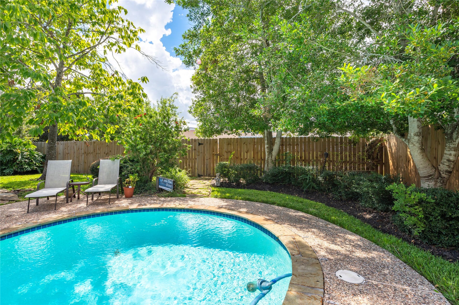 113 Coral Bay Drive, League City, TX 77573 A shady corner by the pool with lush landscaping.