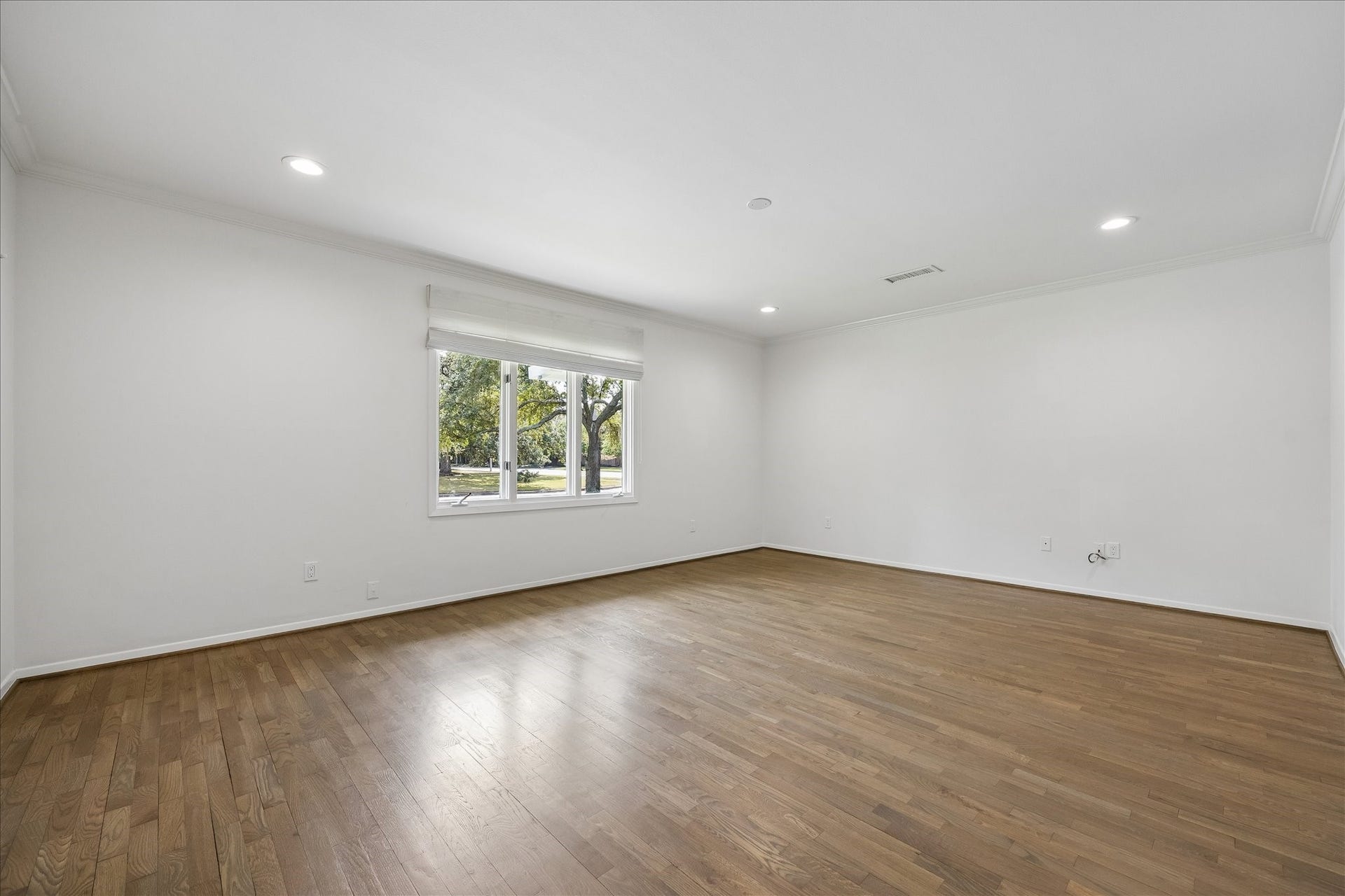 Secondary bedroom with ensuite bath, two nicely sized closets, and overlooks front yard.