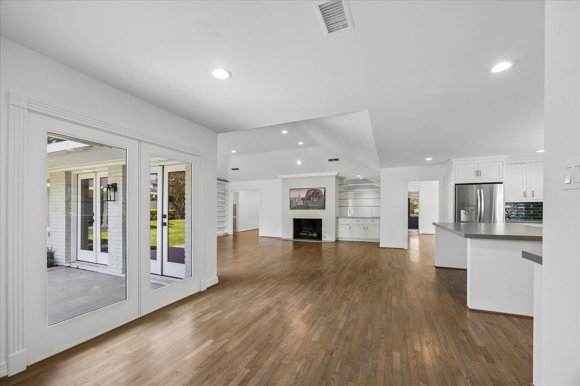 The breakfast area is open to the kitchen and features large windows overlooking the patio.