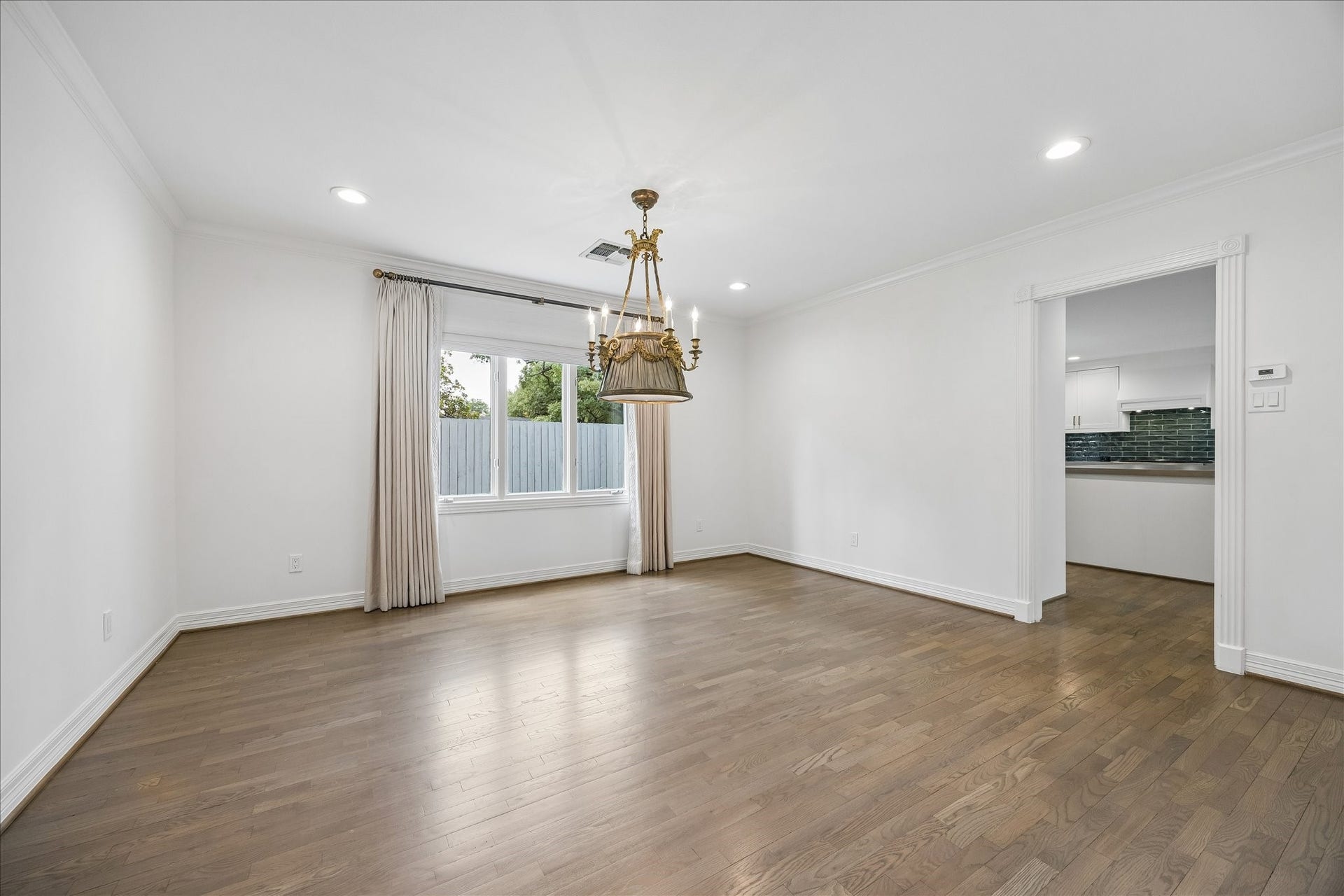 Adjacent to the kitchen, the formal dining room offers a gracious setting for gatherings and opens to the adjoining home office.