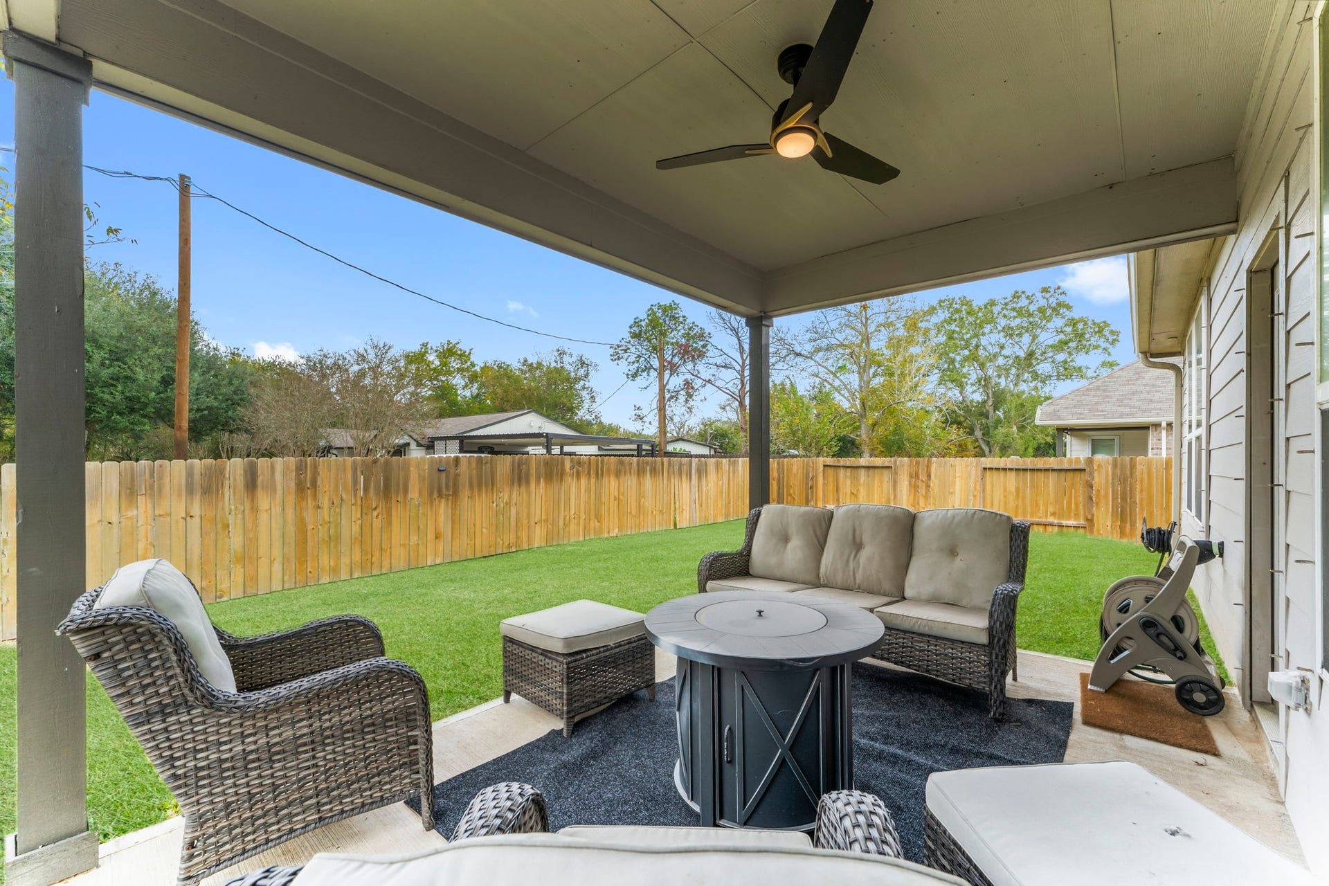 7054 Terra Drive, Manvel, TX 77578 Covered patio with ceiling fan overlooking the fully fenced backyard.