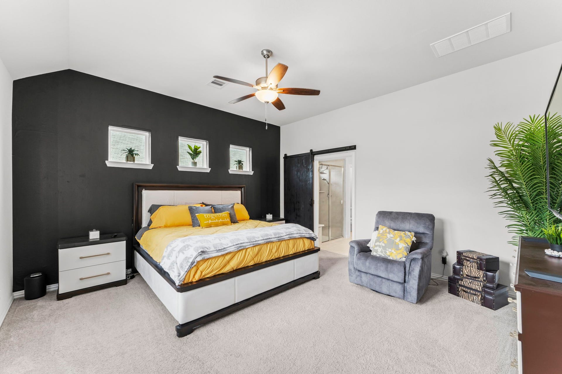 7054 Terra Drive, Manvel, TX 77578 Large primary suite with accent wall, high ceilings, and natural light.