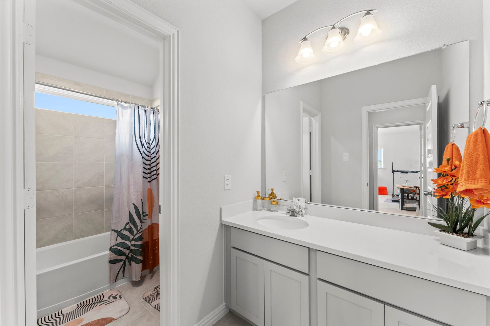 7054 Terra Drive, Manvel, TX 77578 Bright secondary bathroom with a long vanity and modern lighting.