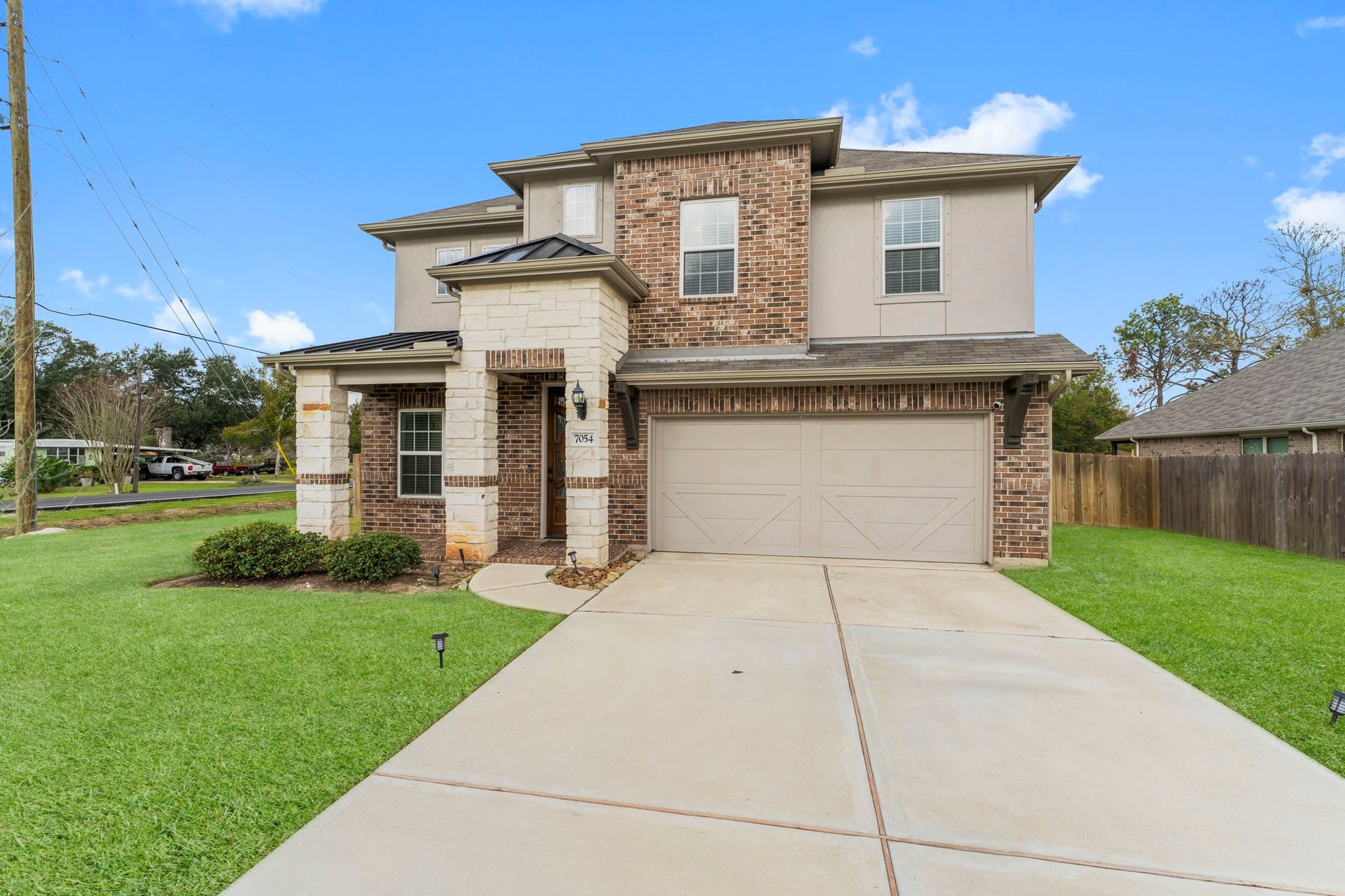 7054 Terra Drive, Manvel, TX 77578 Beautiful Timeless Exterior with an extended driveway, perfect for guest parking!