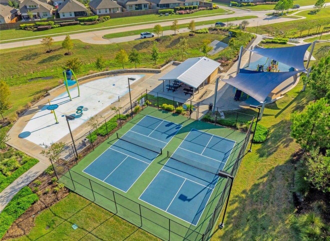 Enjoy a vibrant community lifestyle with access to tennis courts, a splash pad, and a shaded playground, perfect for family recreation and relaxation.