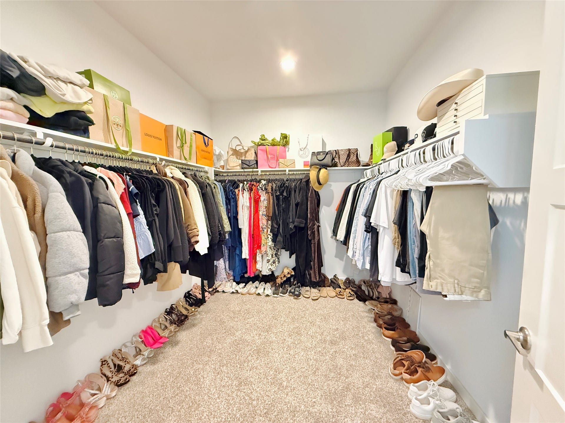 Spacious walk-in closet with ample hanging space, shelving for accessories