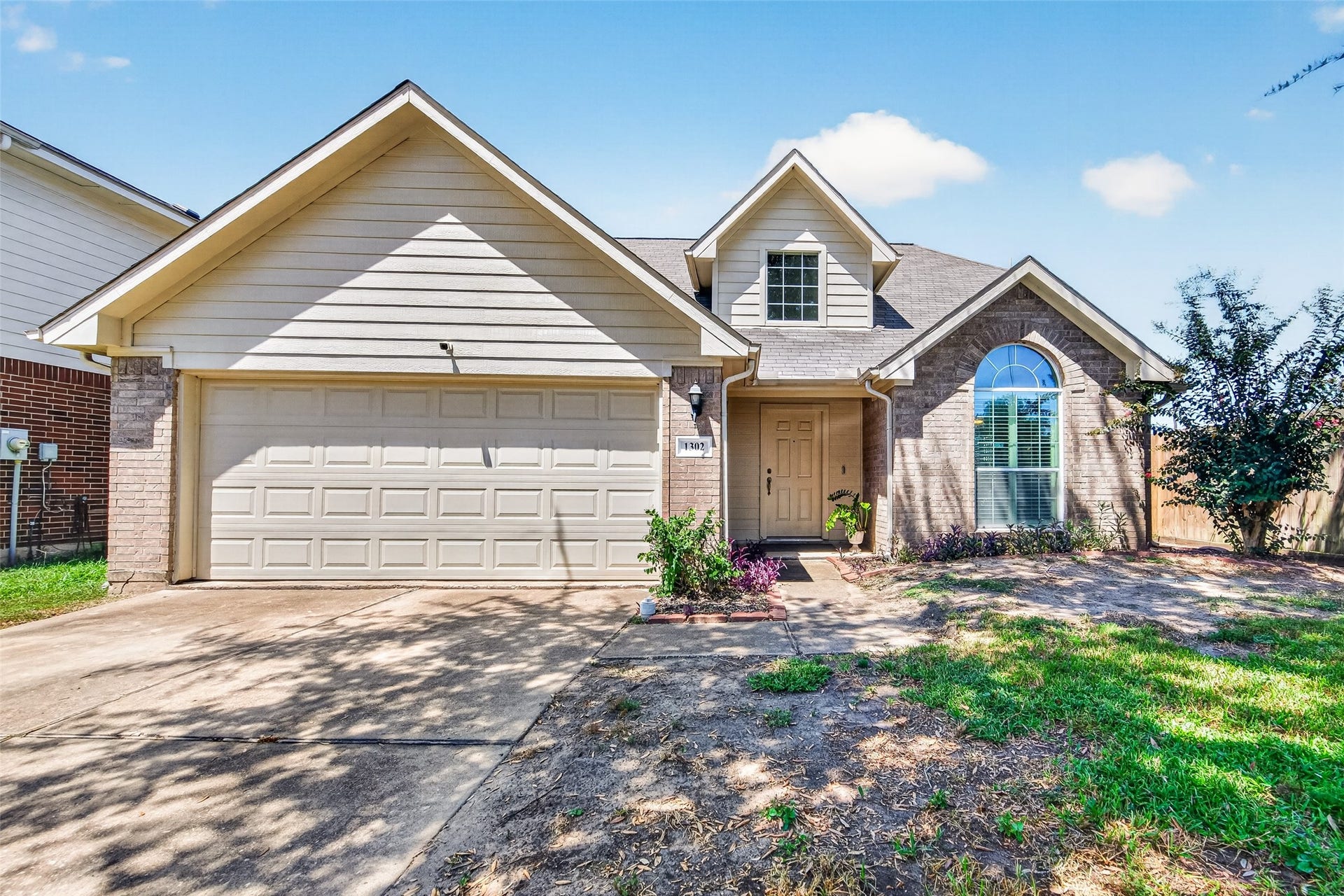 A welcoming traditional exterior set on a quiet Quail Green South cul-de-sac, with a spacious lawn shaded by a mature tree.