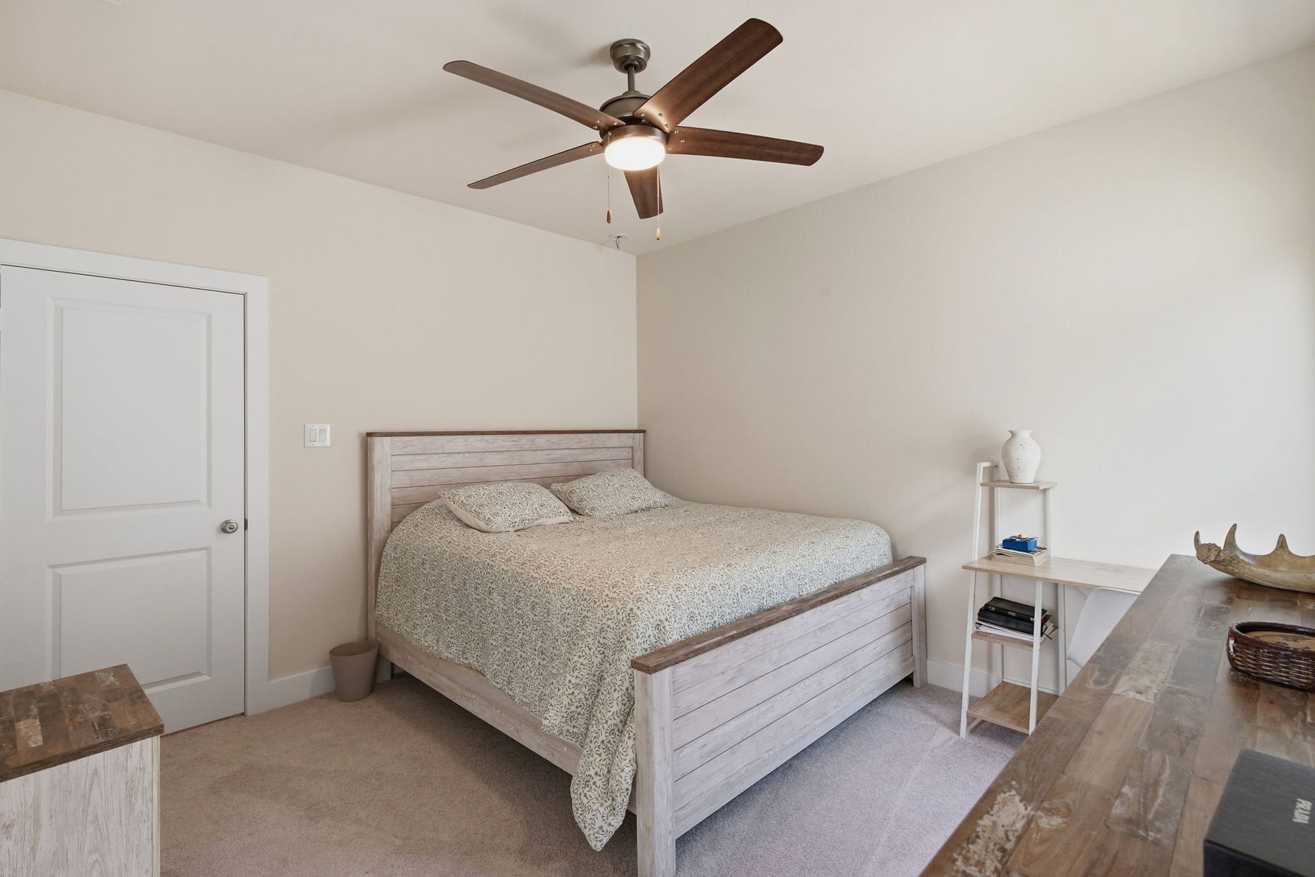 24615 Lukes Landing Way, Tomball, TX 77375 Cozy bedroom featuring a rustic wooden bed frame, soft carpeting, and a ceiling fan for comfort.