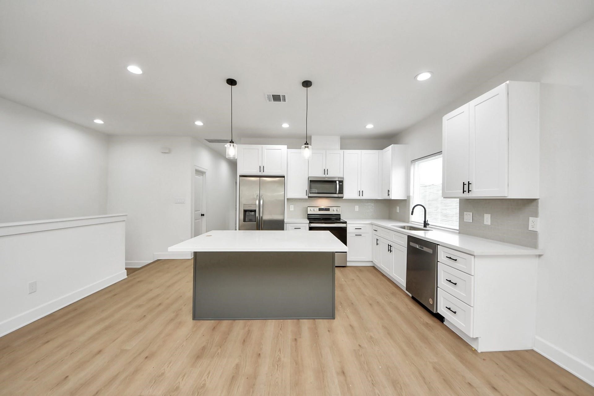 8316 Corinth Street, #c, Houston, TX 77051 A large center island stands as the focal point of this open-concept kitchen design.