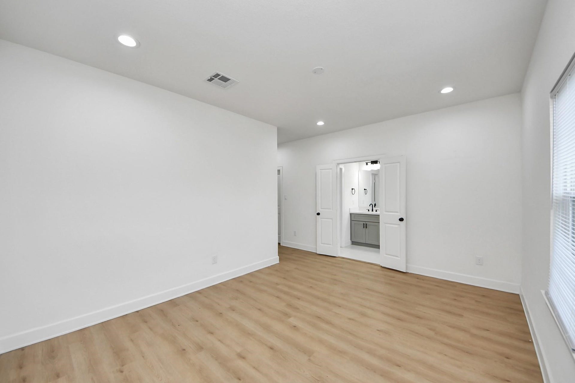 8316 Corinth Street, #c, Houston, TX 77051 Double doors lead directly into the ensuite bath, creating a smooth transition between spaces.