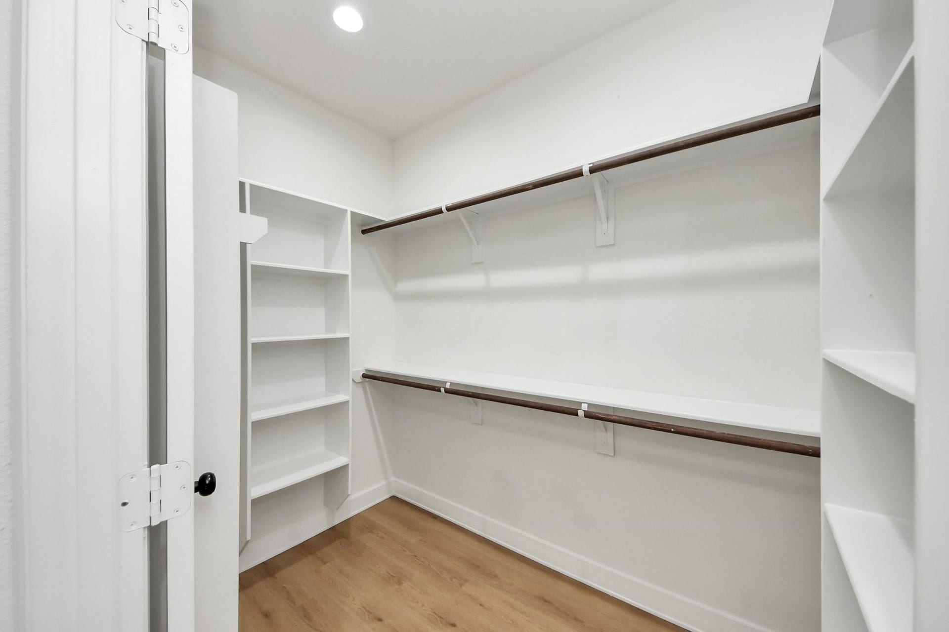 8316 Corinth Street, #c, Houston, TX 77051 This spacious walk-in closet features built-in shelving and dual hanging rods for maximum organization.
