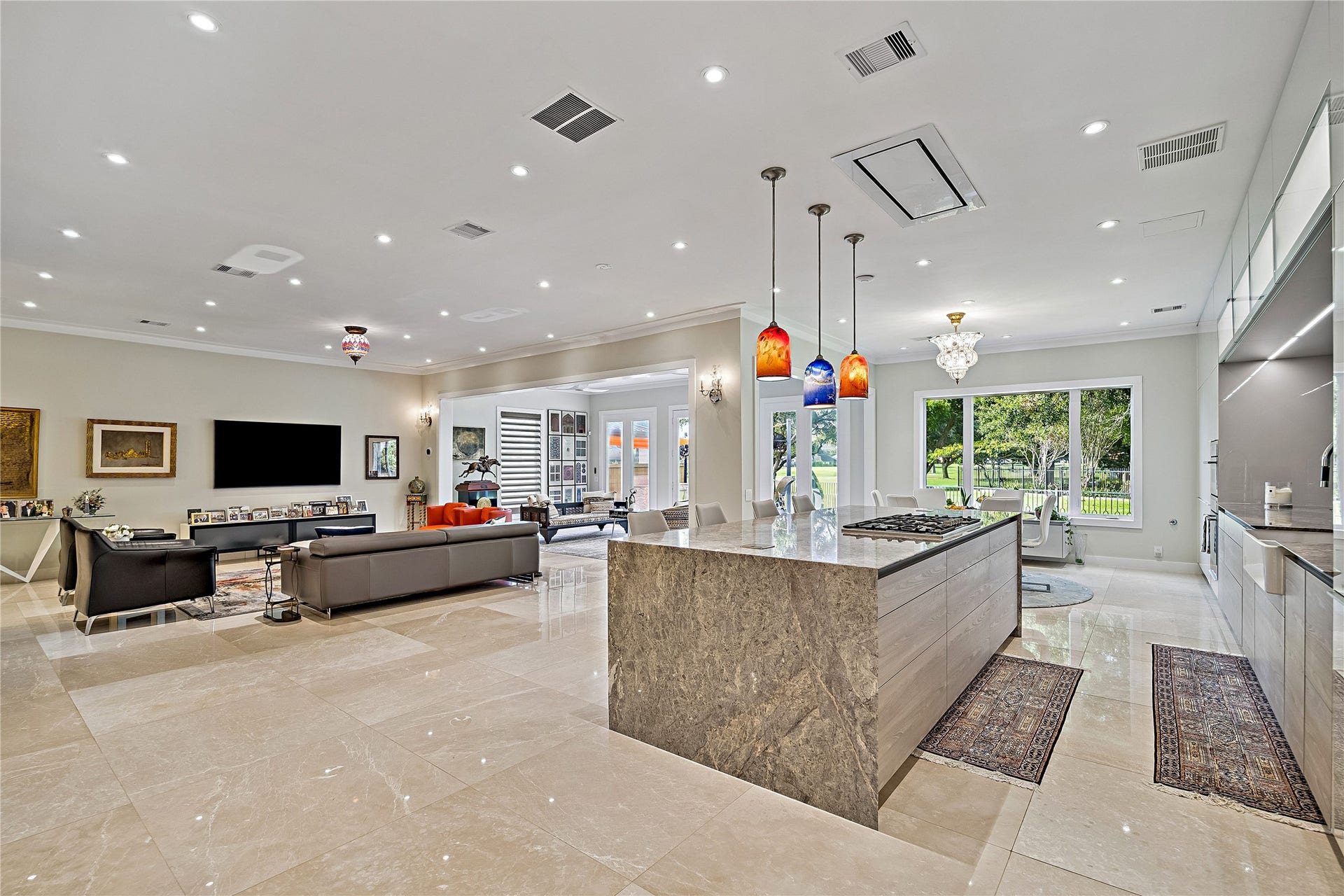 The kitchen anchors the home's main gathering spaces with an expansive island, abundant cabinetry, and an open layout. The adjoining family room offers generous space for entertaining while maintaining connection to the kitchen.