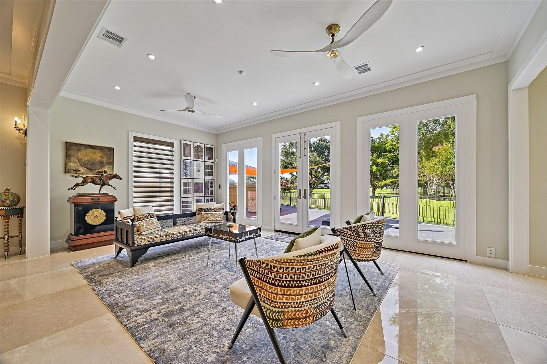 The home's great room, highlights the seamless connection between gathering spaces, contemporary finishes, and carefully designed interior sight lines.