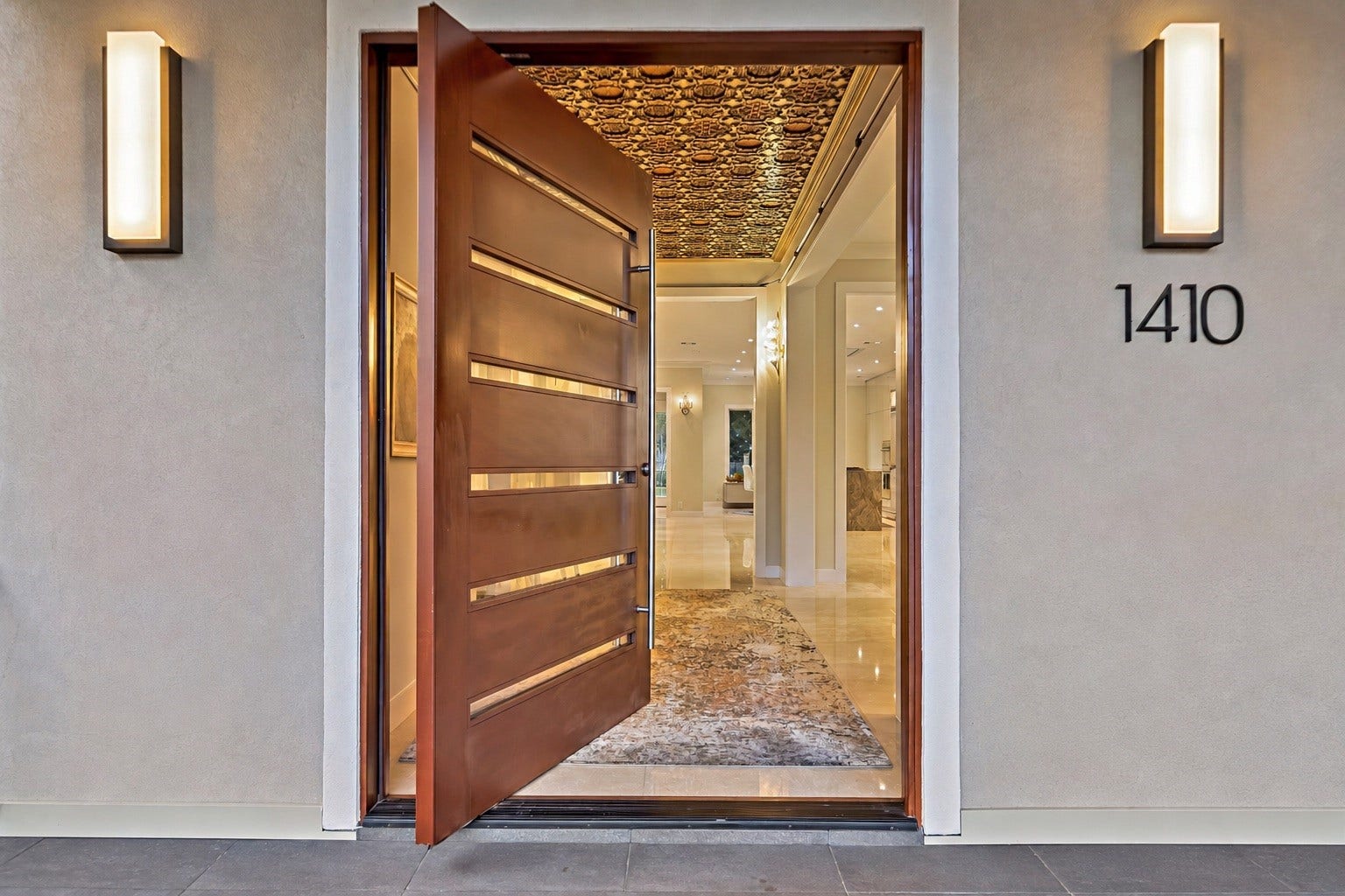 Impressive entry door welcomes guests into a residence distinguished by curated architectural details, sophisticated finishes, and an exceptional collection of Italian interiors.