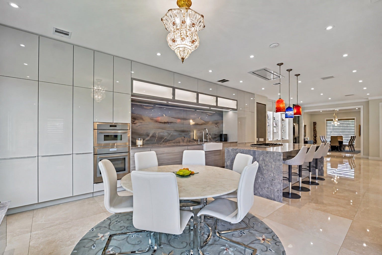 A bright, beautifully integrated breakfast space featuring modern cabinetry, elegant lighting, and an inviting dining arrangement. The breakfast area connects directly to the kitchen.
