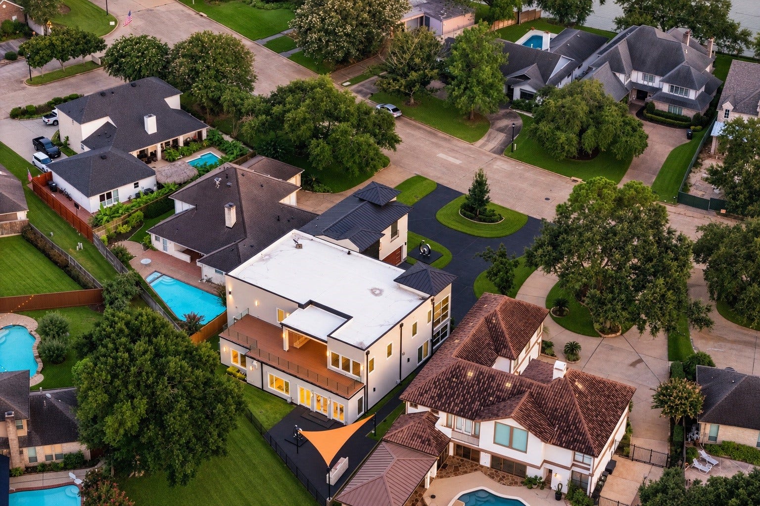 An elevated perspective highlighting the home's substantial footprint, expansive outdoor entertaining areas, upper-level roof terrace, and direct relationship to the golf course. Situated on an approximately 12,492-square-foot lot in Sugar Creek.