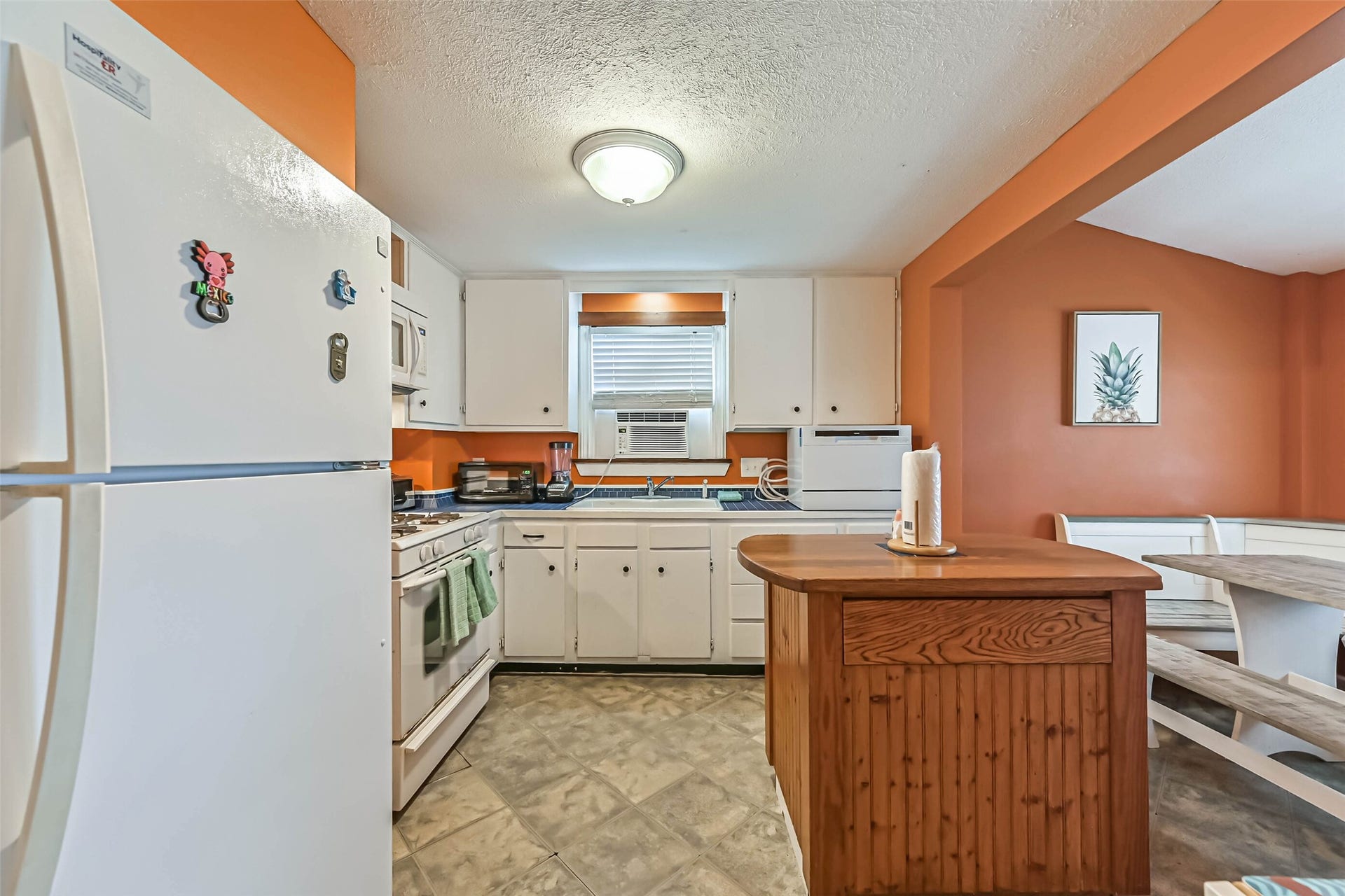 An inviting kitchen with a center island and ample storage, combining functionality with a warm, homey feel.