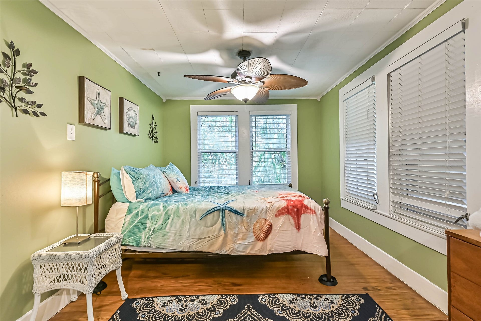 A welcoming bedroom with a comfortable bed and bright windows, creating a relaxing retreat at the end of the day.