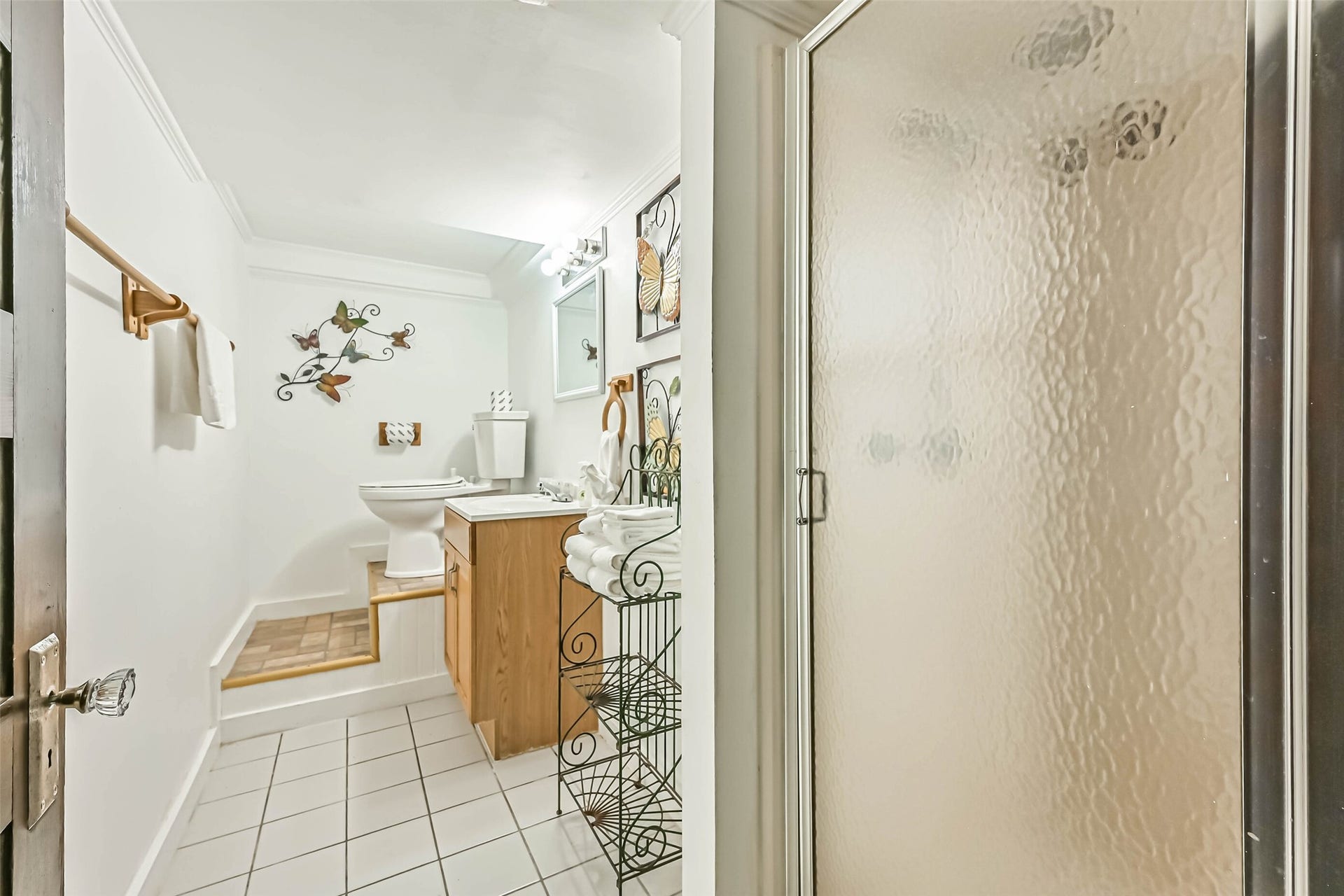A welcoming bathroom with a vanity, decorative accents, and a bright, clean appearance.