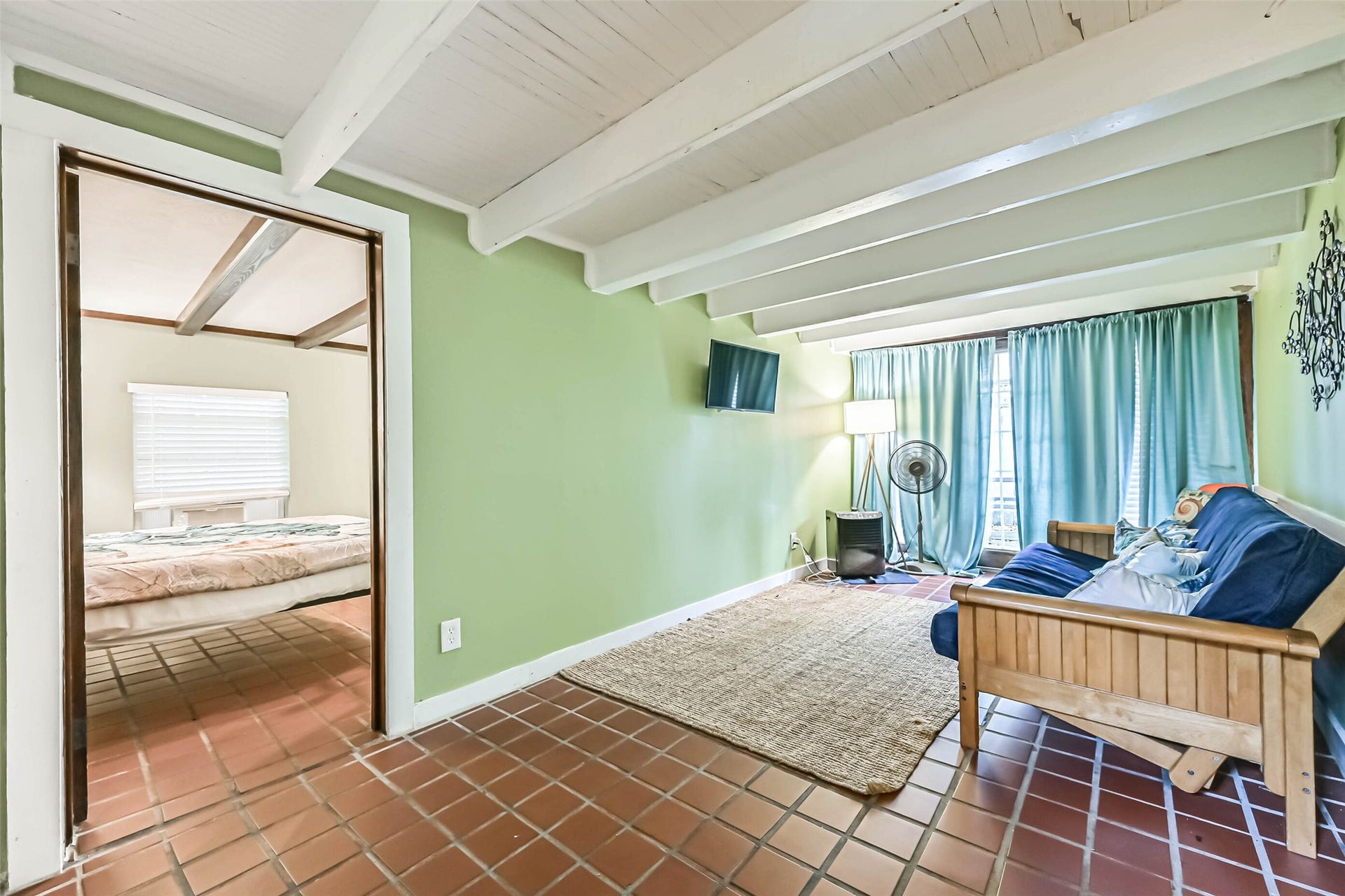 Bright windows and an inviting seating area create a relaxing space to enjoy quiet mornings or casual gatherings.