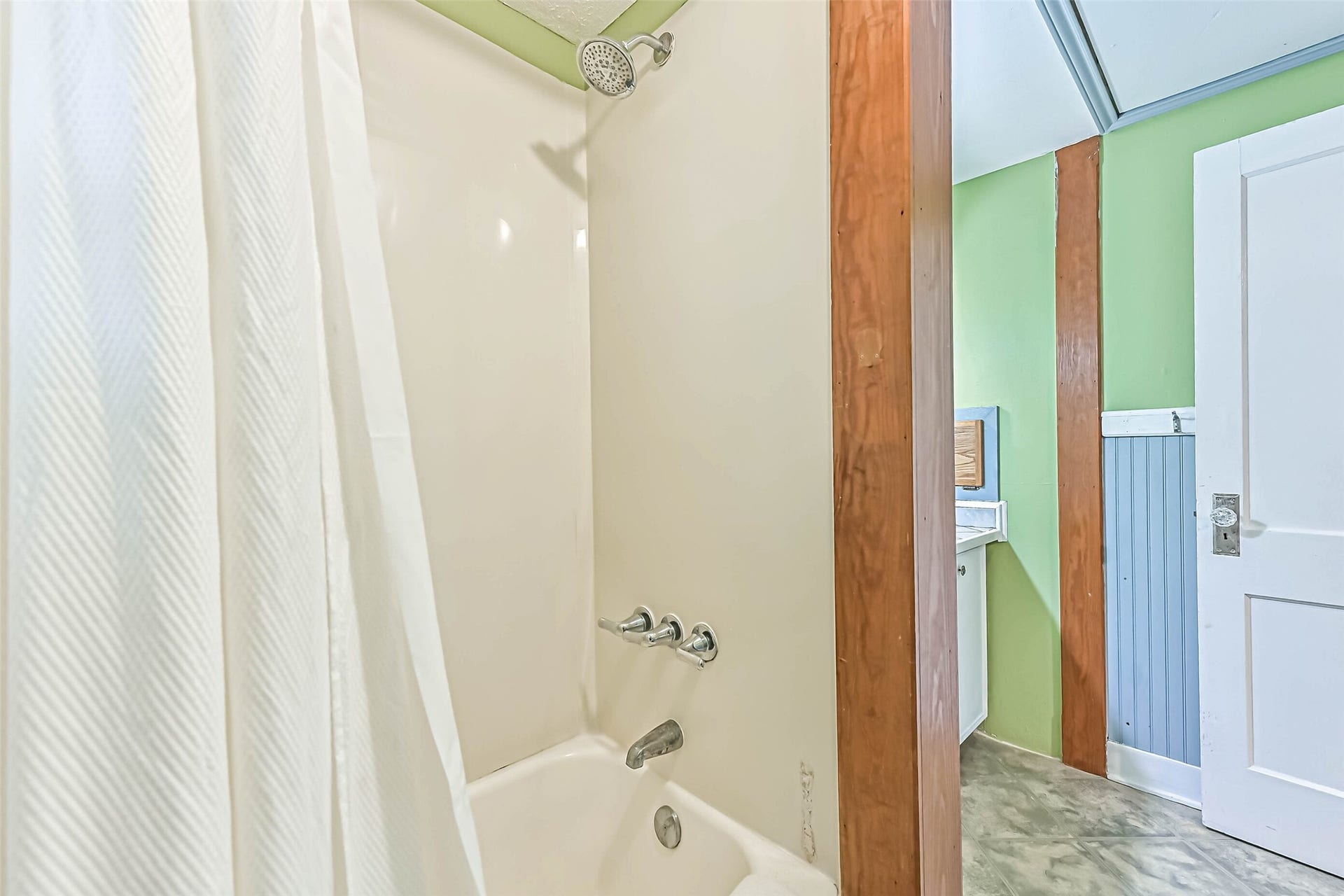 A private shower area with textured glass, creating a simple and functional space to refresh and unwind.
