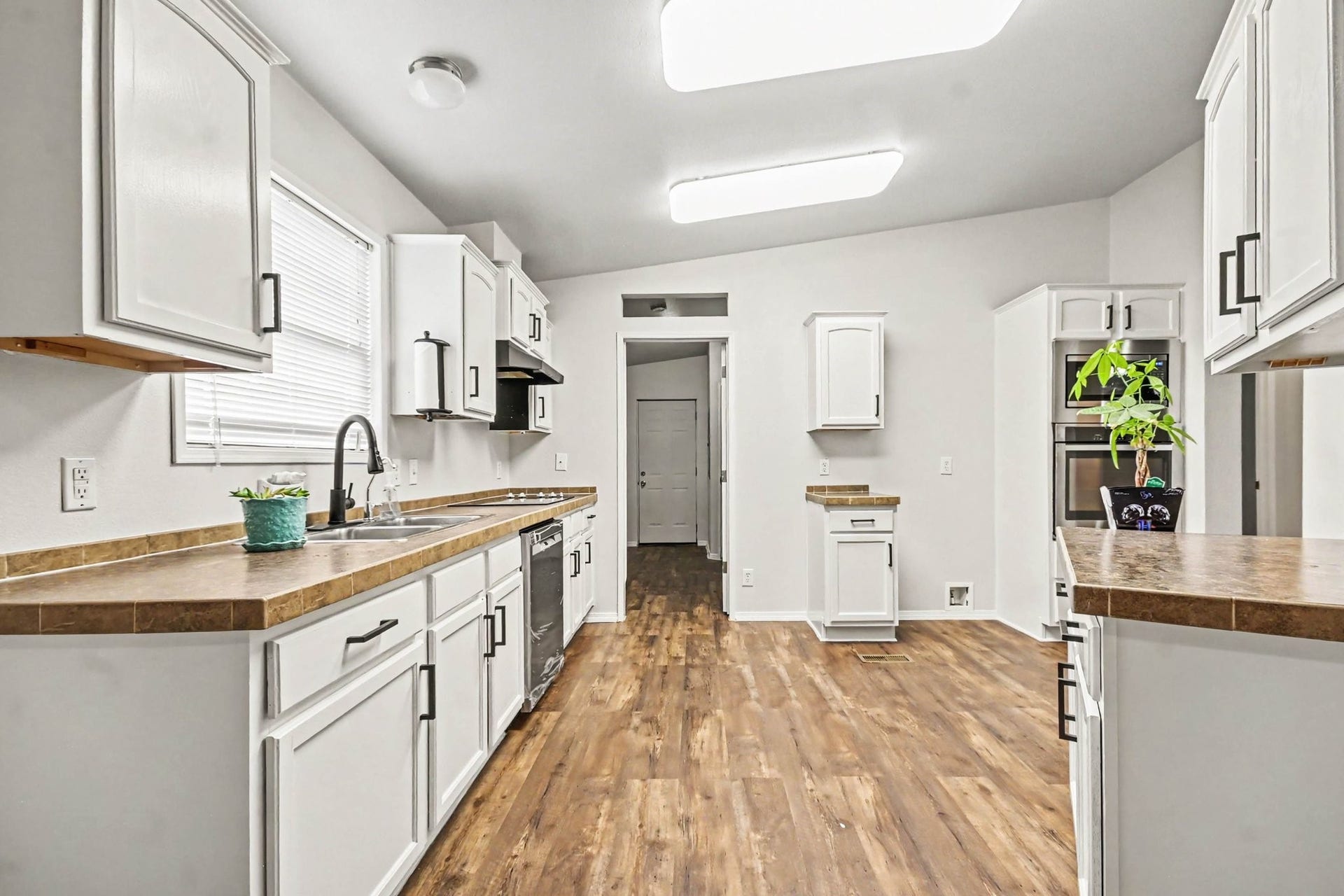 2925 FM 2917, Alvin, TX 77511 Newly painted kitchen has vinyl plank flooring, stainless appliances