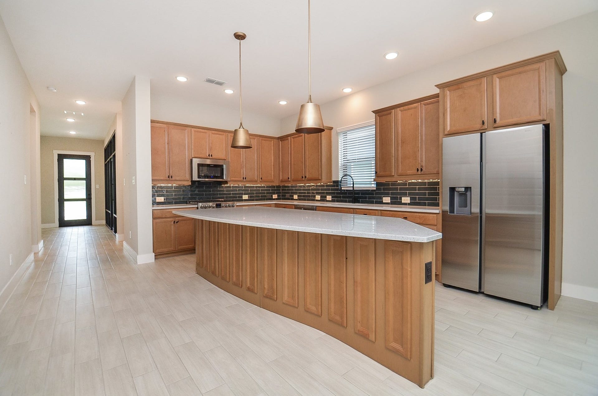 15814 Celebration Lane, Cypress, TX 77433 Oversized island creates a natural hub for casual dining, meal prep and conversation.