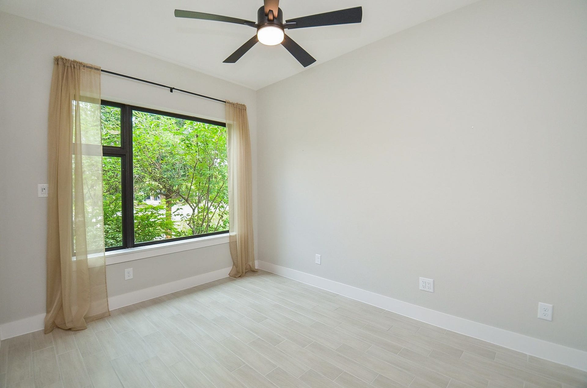 15814 Celebration Lane, Cypress, TX 77433 Large window brings outdoor views into this inviting secondary bedroom.