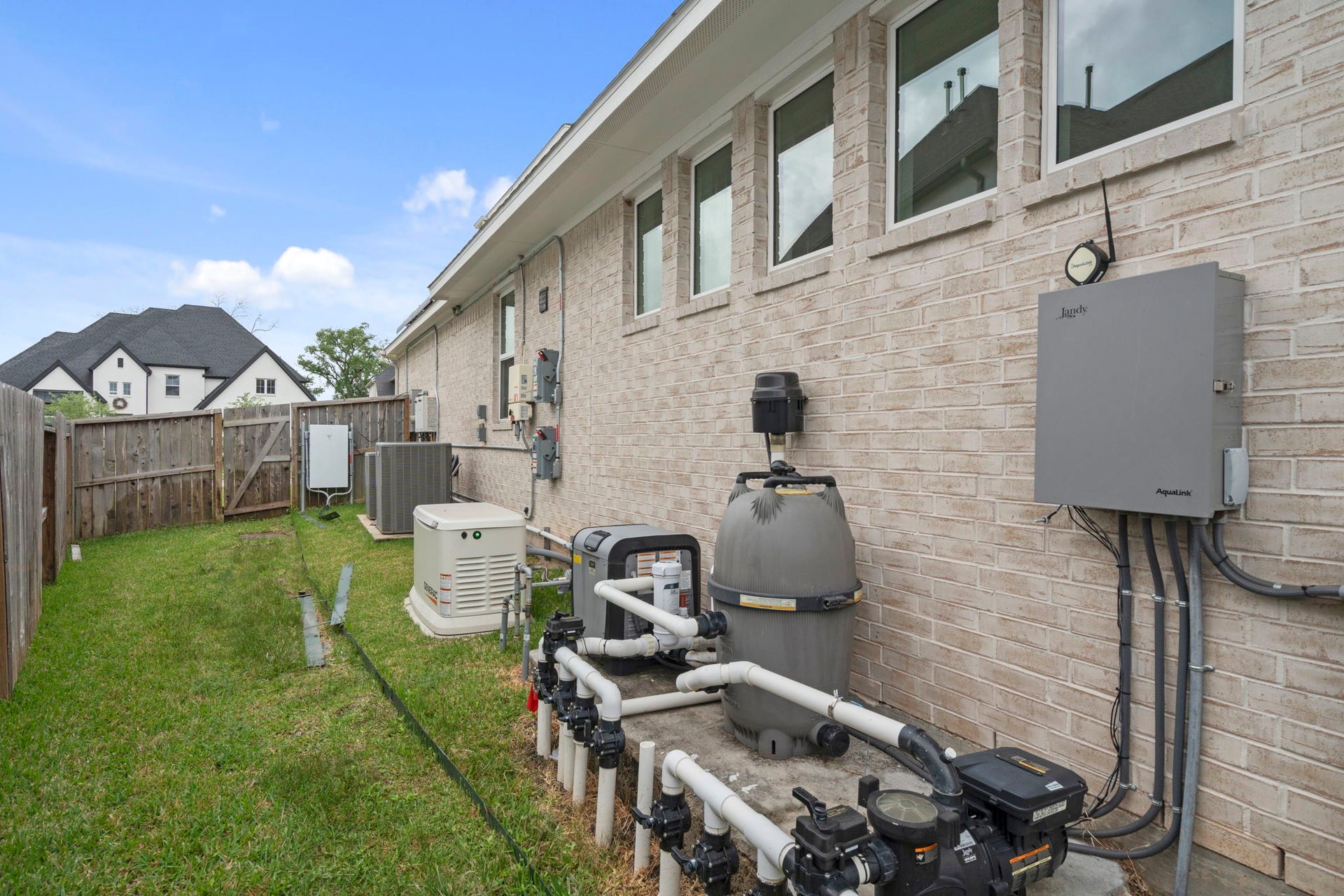 10315 Fountain Shore Drive, Missouri City, TX 77459 Huge side yard with Electric generator and utility equipment supporting the home's energy efficiency.