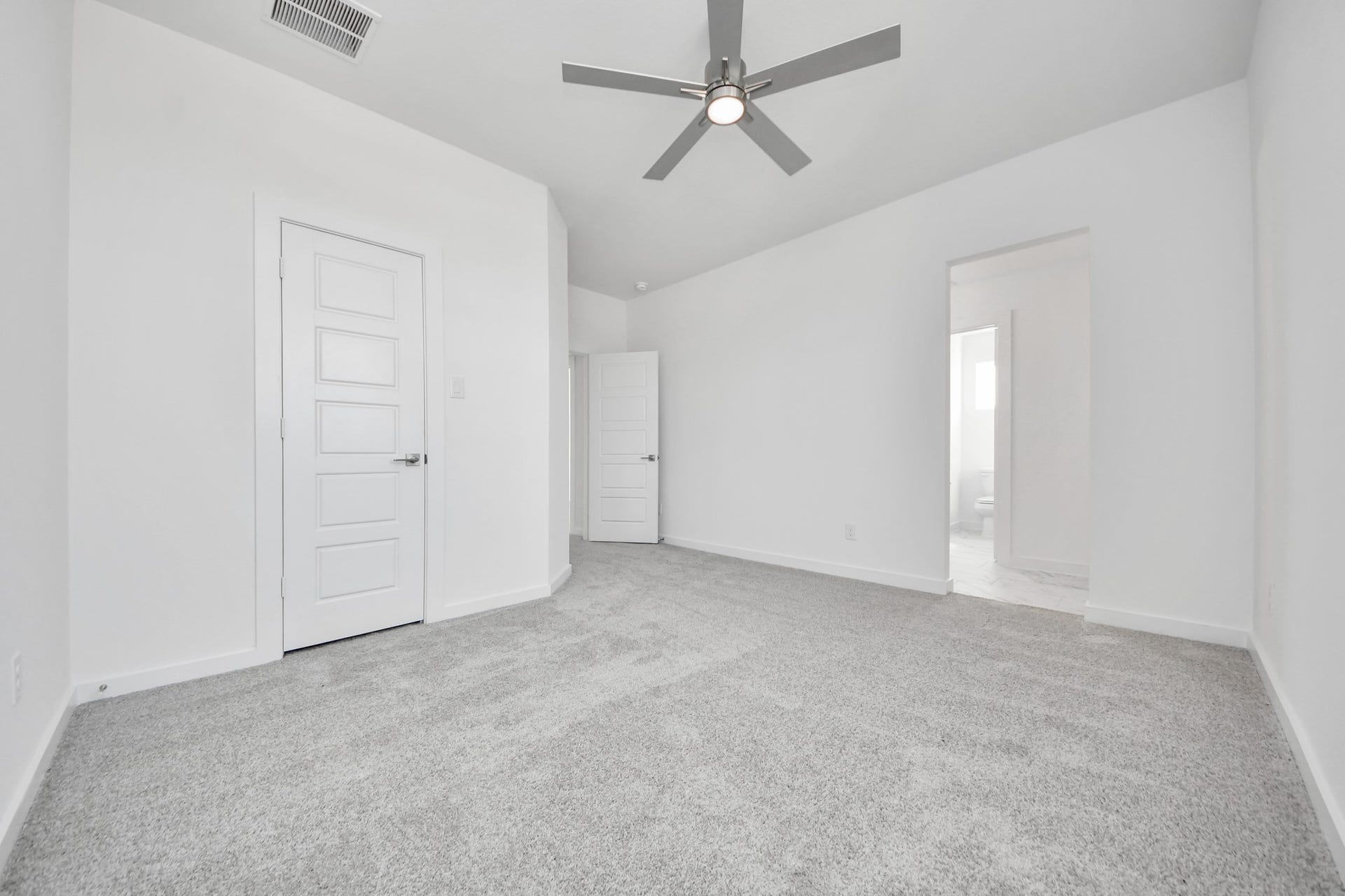 Secondary bedroom features plush carpeting, large windows that let in plenty of natural light, bright paint, and spacious closets.