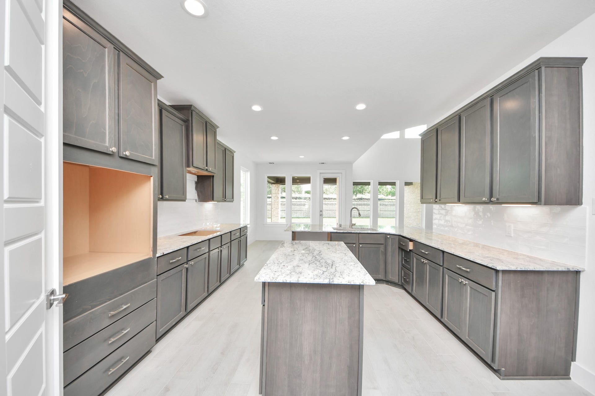 The kitchen is a culinary haven, featuring granite countertops, a tile backsplash, stainless steel appliances, 42 upper cabinets, and undercabinet lighting.