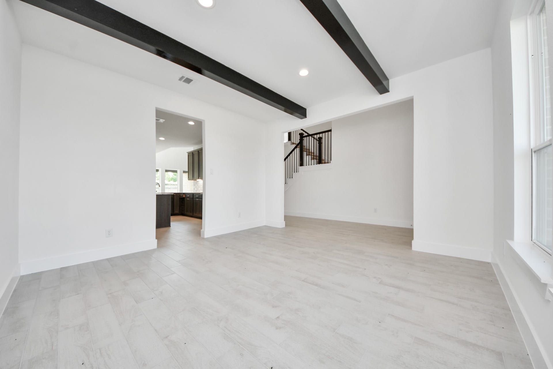 Make memories gathered around the table with your family and friends! This spacious dining room features elegant flooring, custom paint, and adjacent to family room and kitchen for open concept feel.