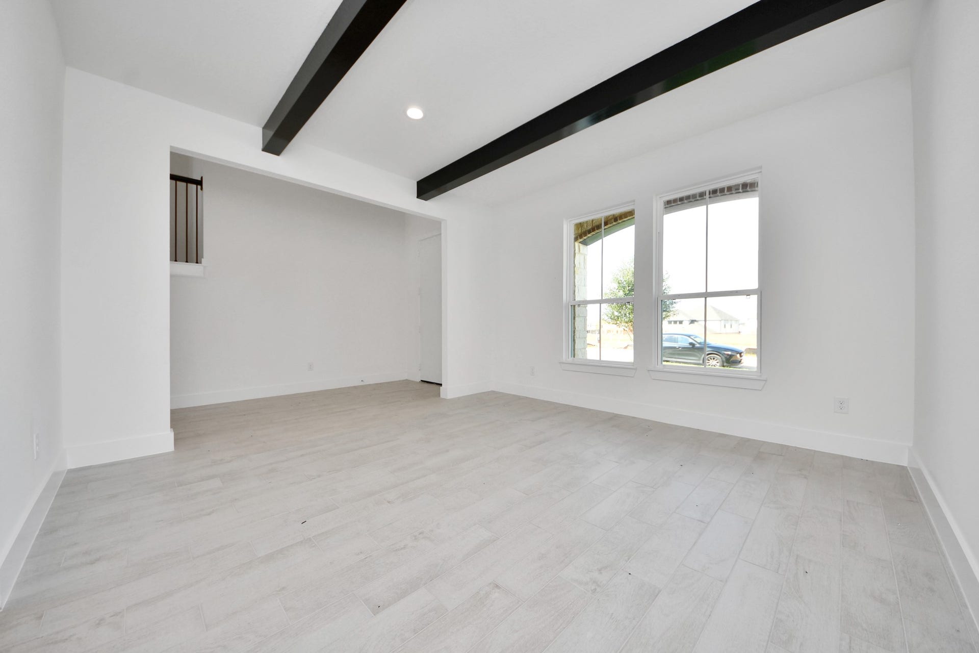 Craft enduring memories with loved ones around the table! This roomy dining area boasts stylish flooring, personalized paint, and is conveniently situated next to the family room and kitchen, fostering an open and inclusive ambiance.