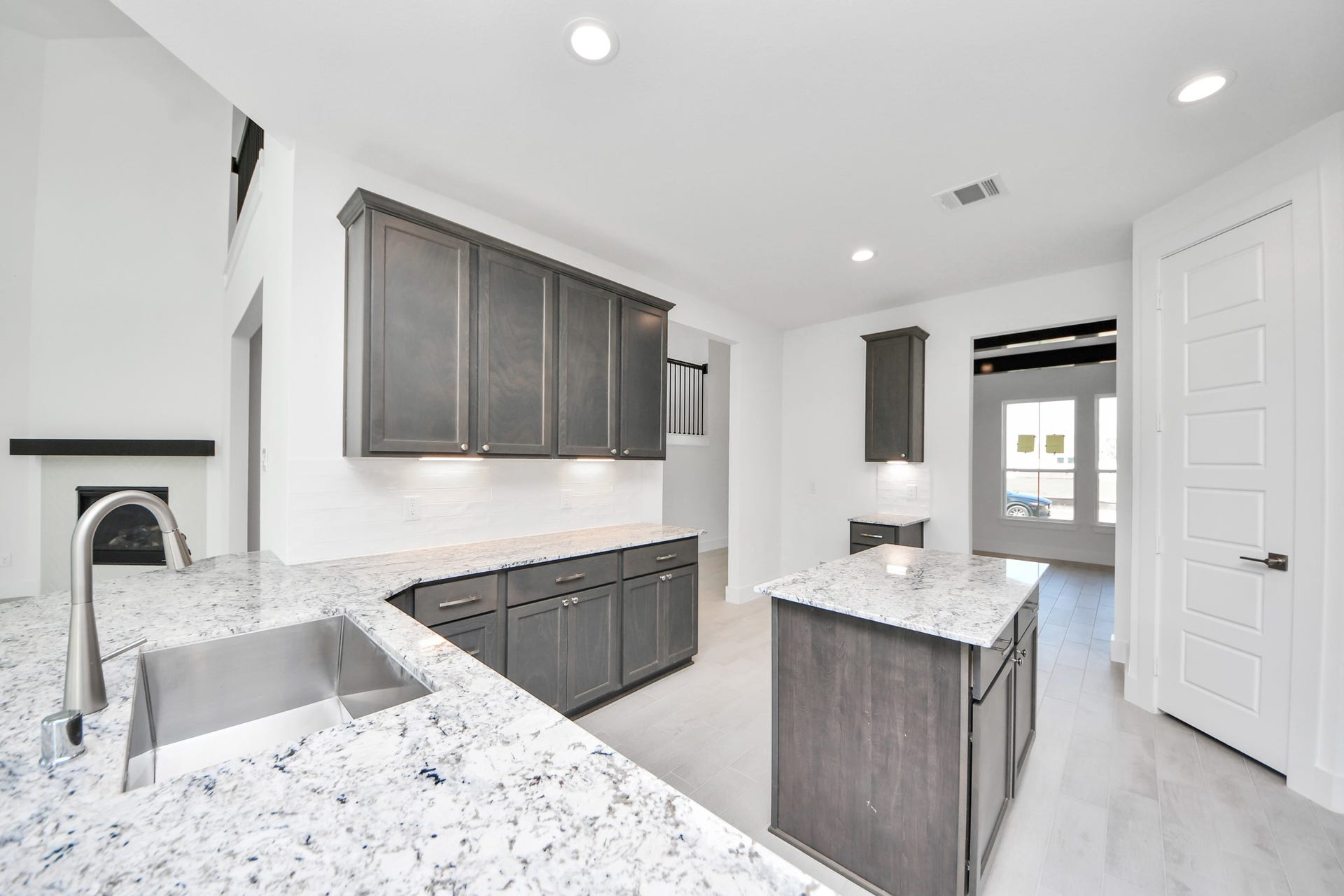 The open concept effortlessly connects the kitchen to the expansive family room, forming a perfect hub for gatherings. This seamless flow creates an inviting space where cooking and socializing come together harmoniously.