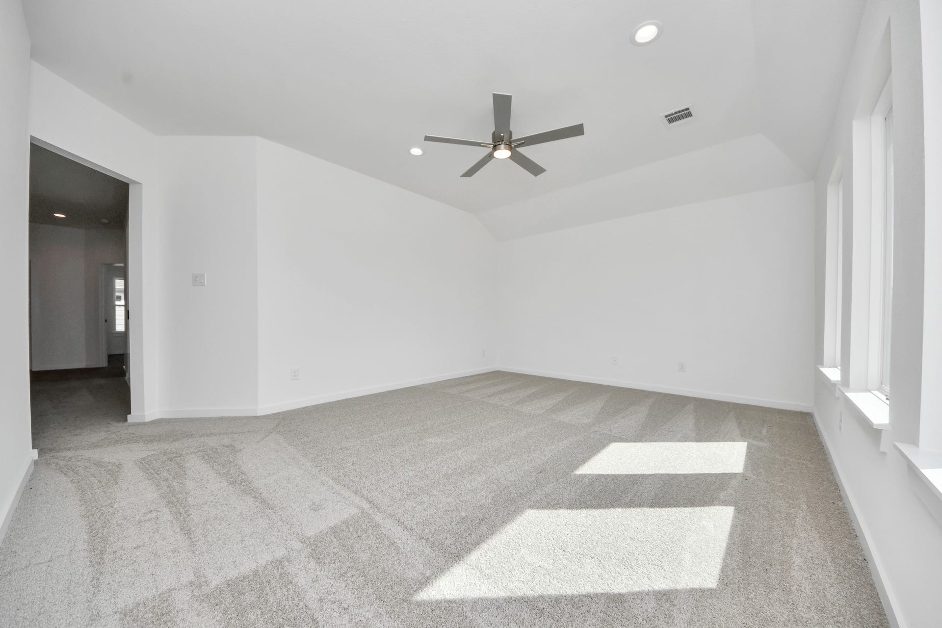 Ascend to relaxation in this fantastic game room! Ideal for both casual gatherings and adult gaming, it boasts plush carpet, lofty ceilings, custom paint, and ample windows for abundant natural light