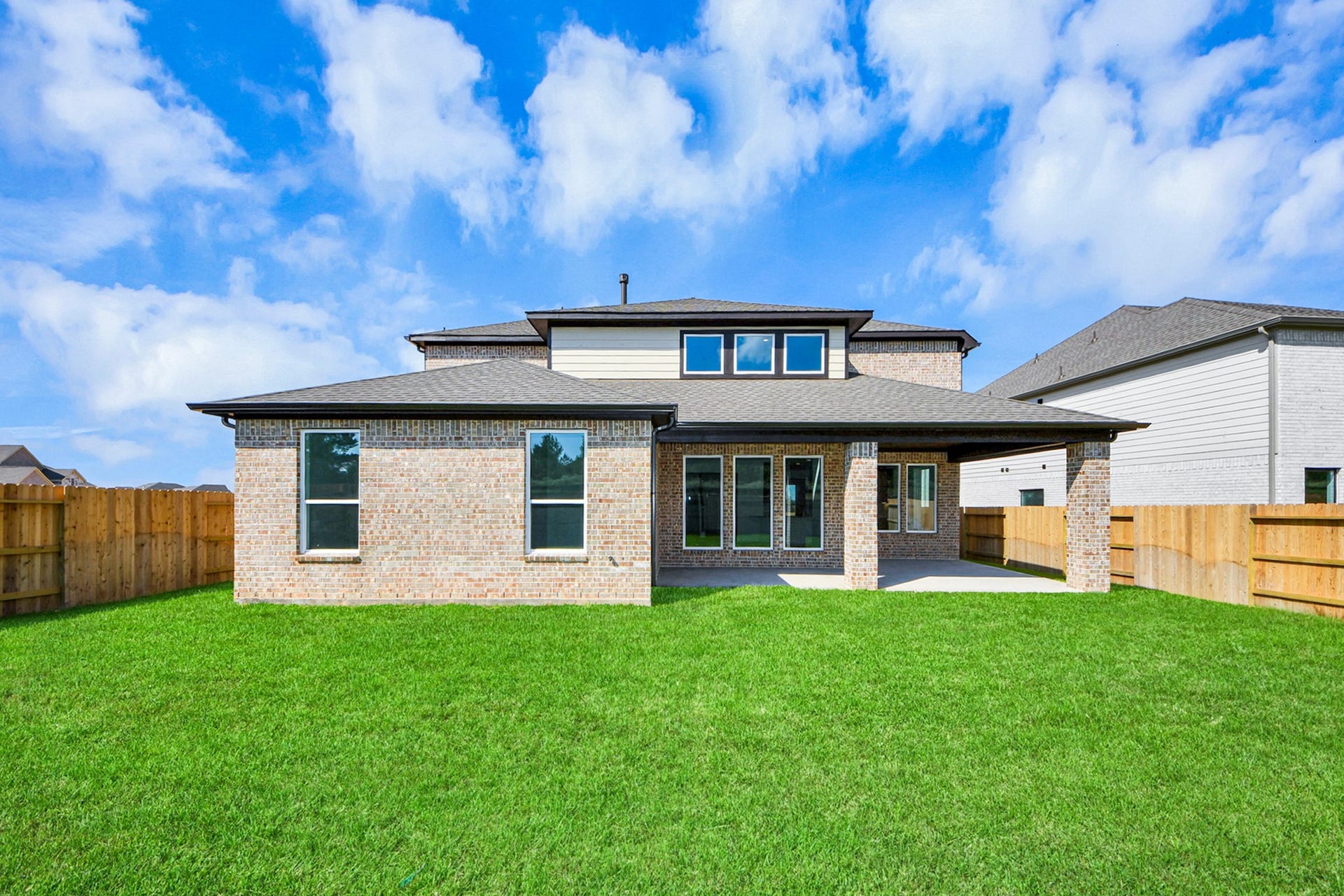 Experience outdoor living at its finest on this expansive covered patio, thoughtfully designed for BBQs and delightful outdoor dining.
