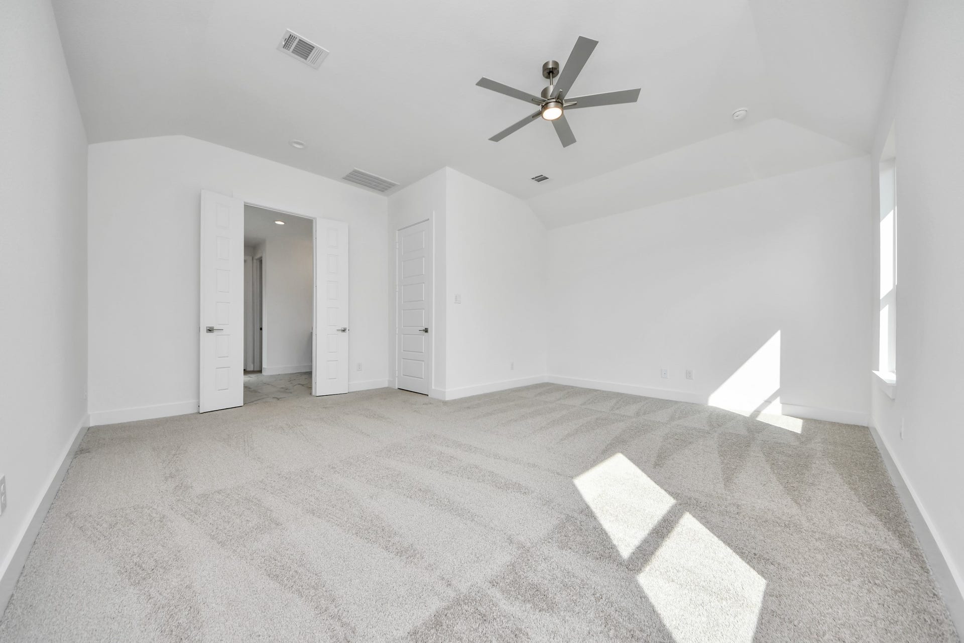 Retreat to the luxurious primary suite, your perfect escape for unwinding after a long day. Located on the first floor, this spacious room features plush carpeting, calming paint tones, high ceilings, and large windows with privacy blinds.