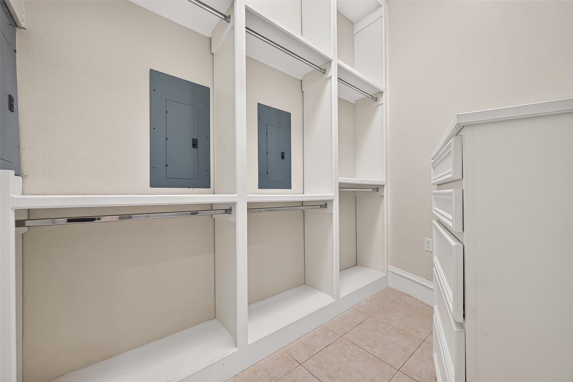4011 Westerdale Drive, Fulshear, TX 77441 His and Hers deluxe walk-in closets with multiple tier clothing racks and built-in drawers.