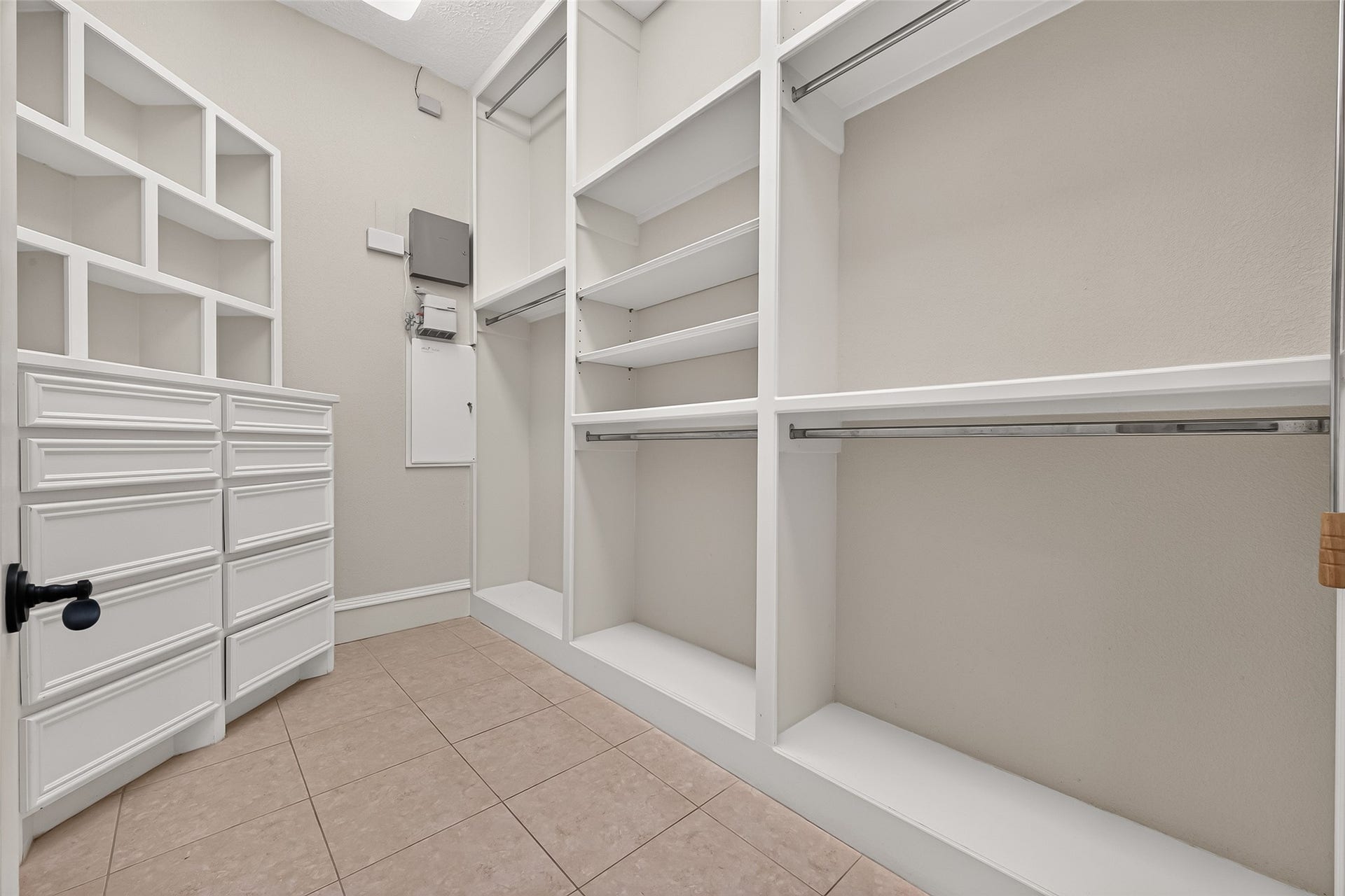 4011 Westerdale Drive, Fulshear, TX 77441 His and Hers deluxe walk-in closets with multiple tier clothing racks and built-in drawers.