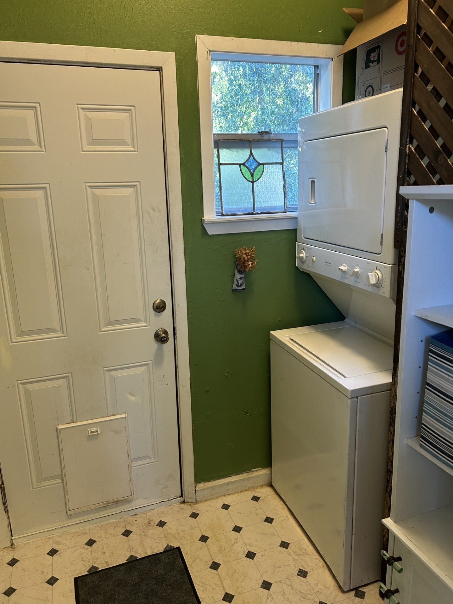 3911 Bernardo De Galvez Avenue, Galveston, TX 77550 Utility room with stacked washer dryer and back door.