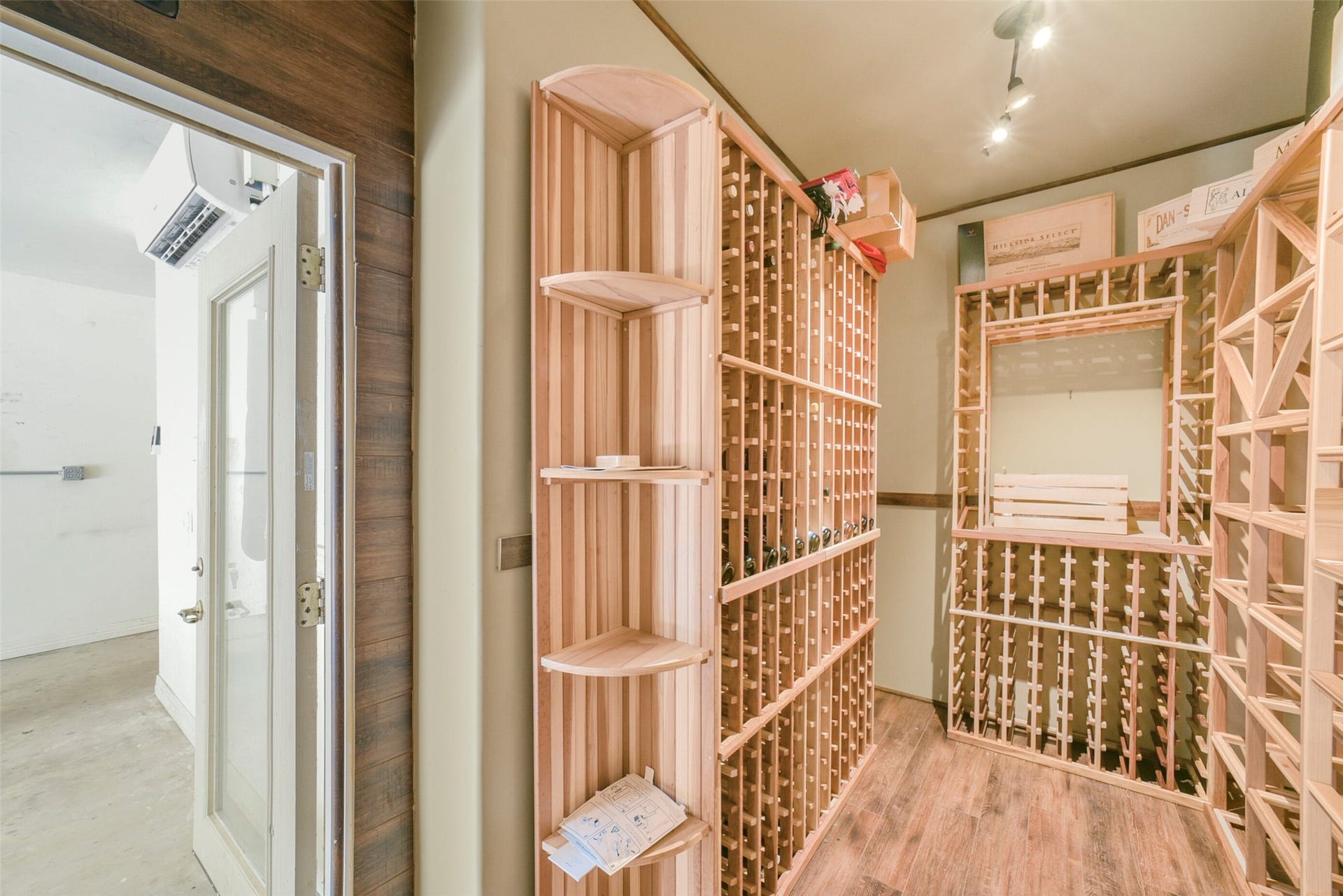 3522 Wellspring Lake Drive, Fulshear, TX 77441 View of Wine Room Built into the Garage Space. Note: the Garage has Extra Insulation as well as a Wall unit A/C to keep the temperature outside of the wine room perfect! They truly thought of Everything!
