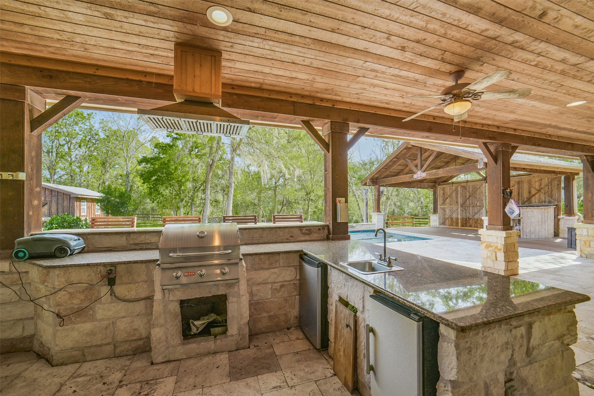 3522 Wellspring Lake Drive, Fulshear, TX 77441 LOOK AT THIS OUTDOOR KITCHEN!!!! Custom stone work surround, Vented hood to control smoke from grill the Wooded Designed Ceiling with Beams and Stone work leading out to the pool, NO THIS ISN'T A RESORT, it
s your FUTURE BACKYARD!!!