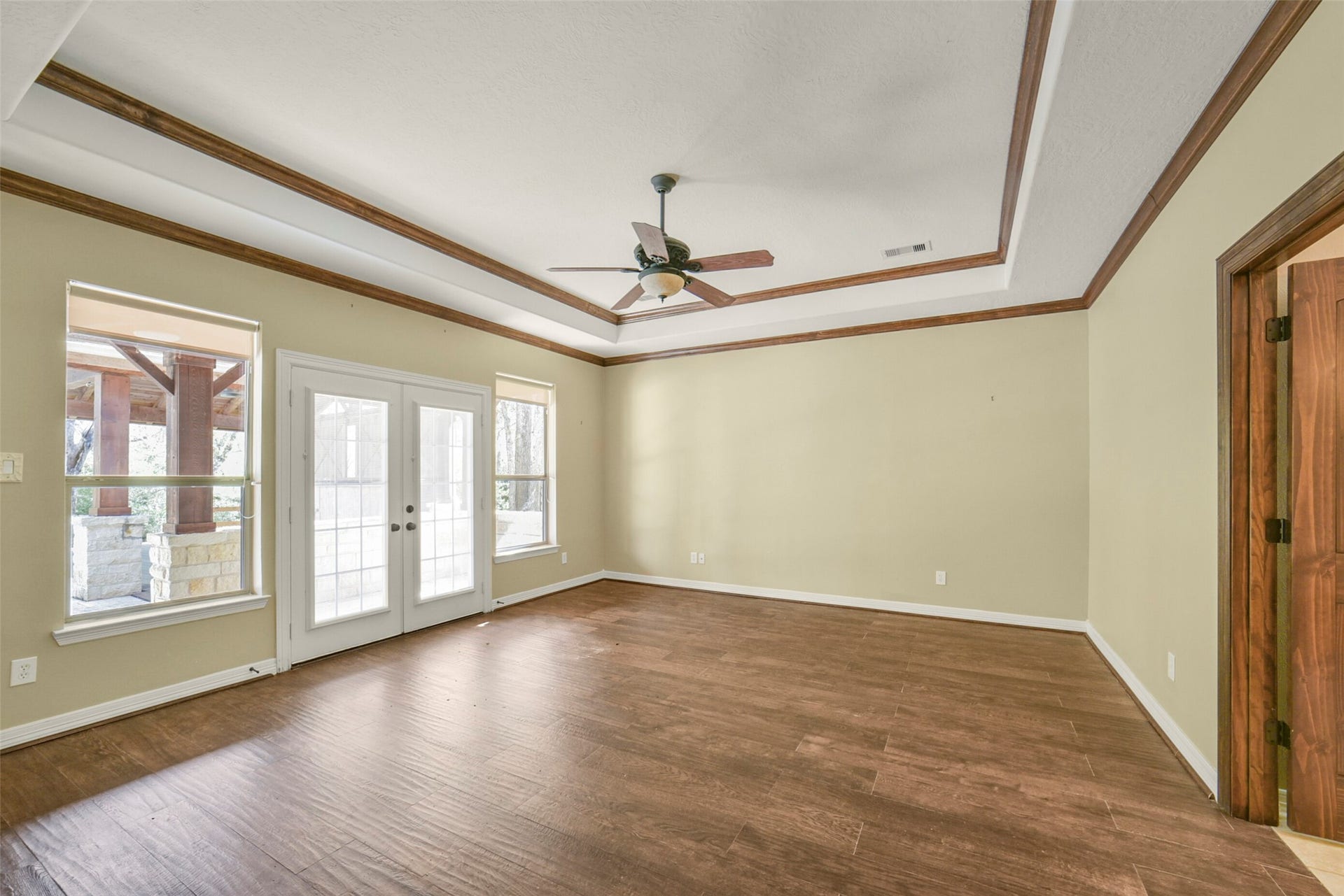 3522 Wellspring Lake Drive, Fulshear, TX 77441 Massive Primary Bedroom with Wood floors, tray ceilings, French Door access to Outdoor Oasis with Custom Crown Moulding!