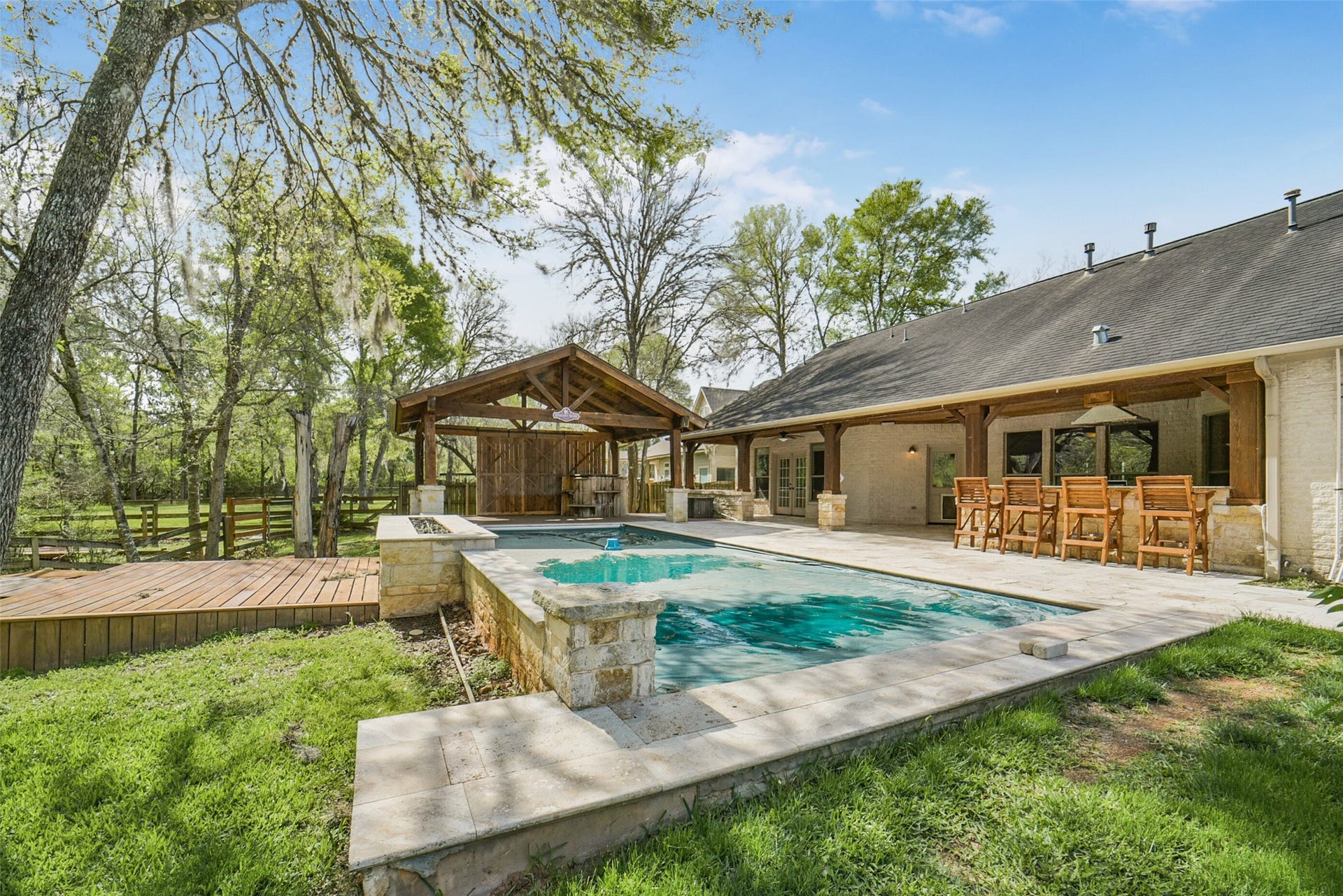 3522 Wellspring Lake Drive, Fulshear, TX 77441 Take in this View of the AMAZING Pool with Fire Place Feature along the Back Leading to a custom deck area with walking path!!! STUNNING!!!