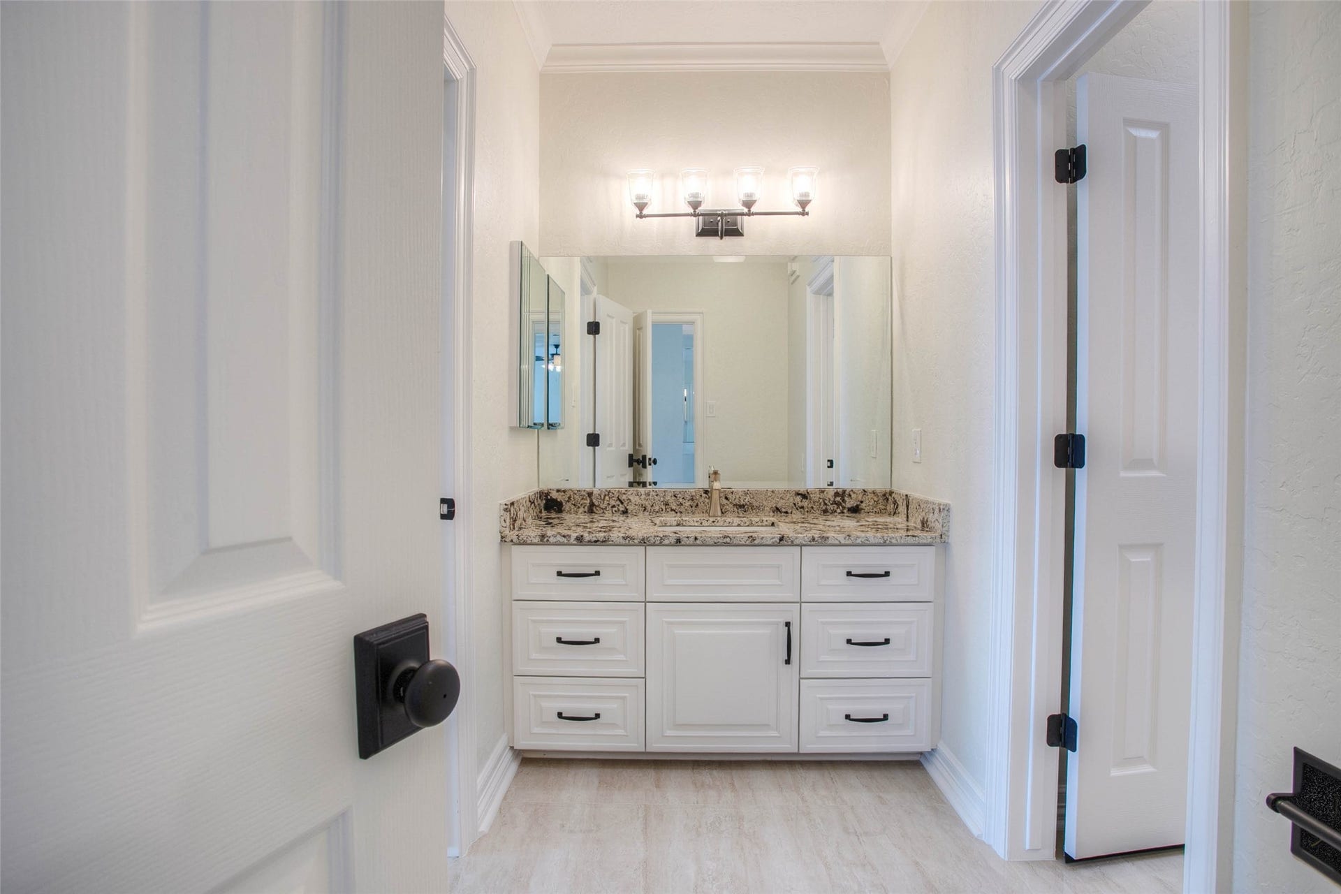 12092 Sagittarius Drive E, Willis, TX 77318 Elegant Hollywood bath featuring a stylish sink and vanity, offering a perfect blend of functionality and sophistication.