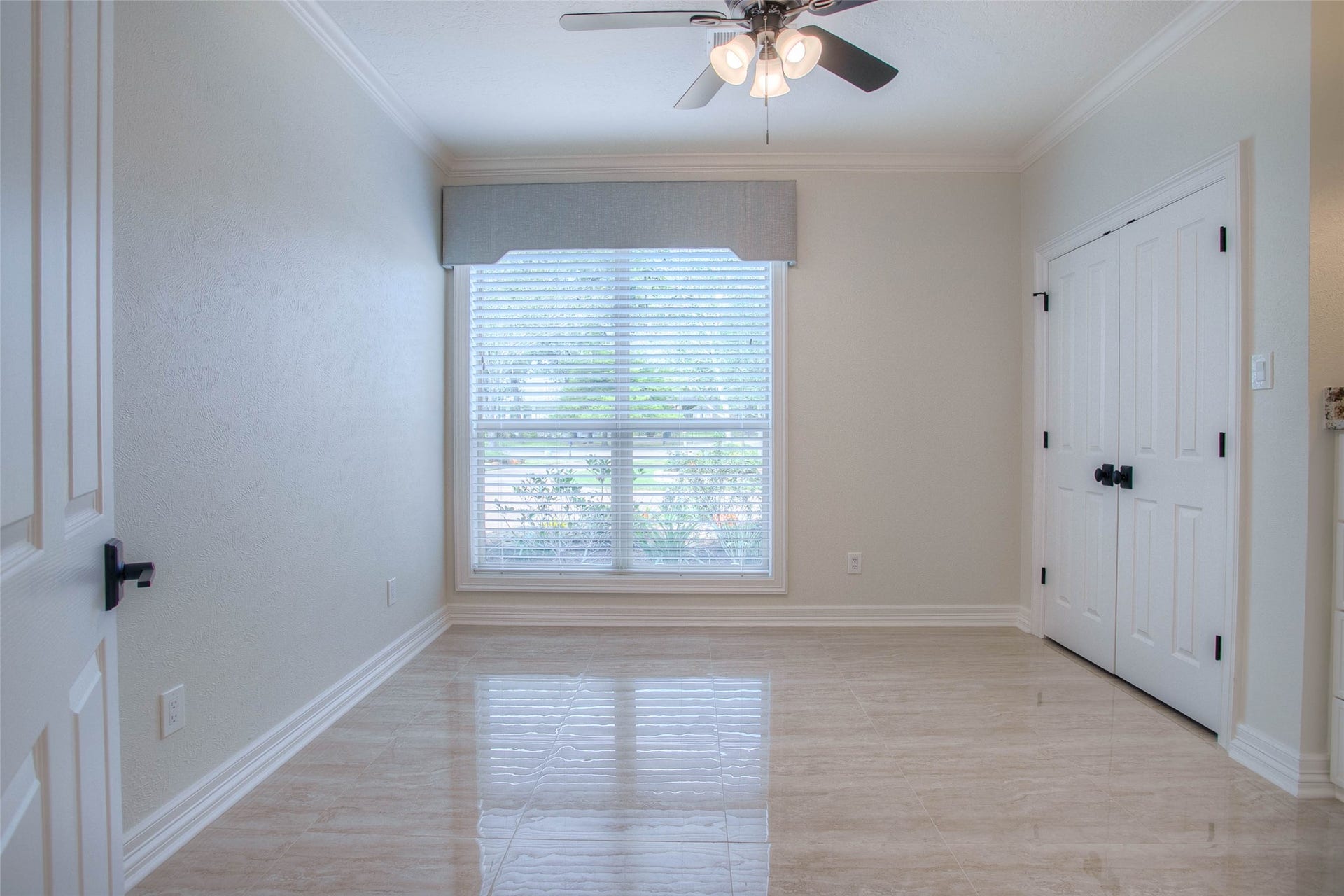 12092 Sagittarius Drive E, Willis, TX 77318 Bright and inviting, this guest bedroom offers serene natural light and elegant finishes, providing a perfect retreat for visitors.
