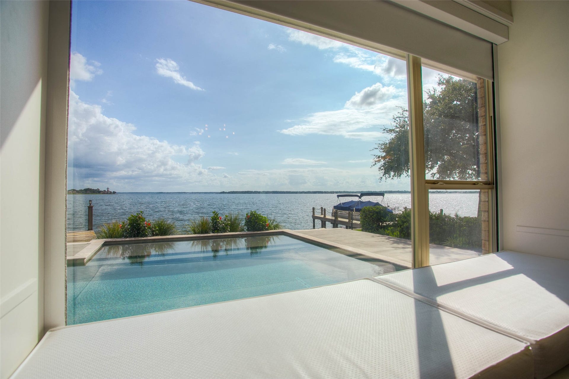12092 Sagittarius Drive E, Willis, TX 77318 Experience serene waterfront living with stunning lake views from your private poolside oasis.