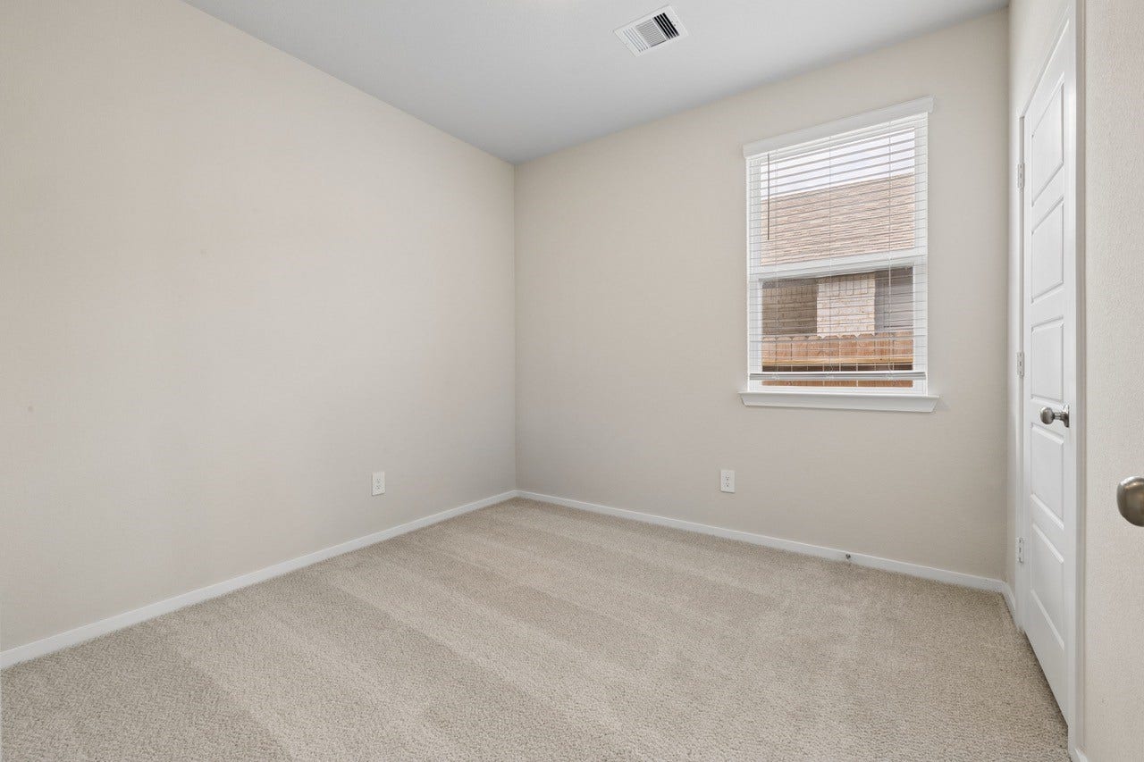 384 Sunrise Ranch Dr, Montgomery, TX 77316 Cozy bedroom featuring soft, neutral carpeting and a window providing natural light.