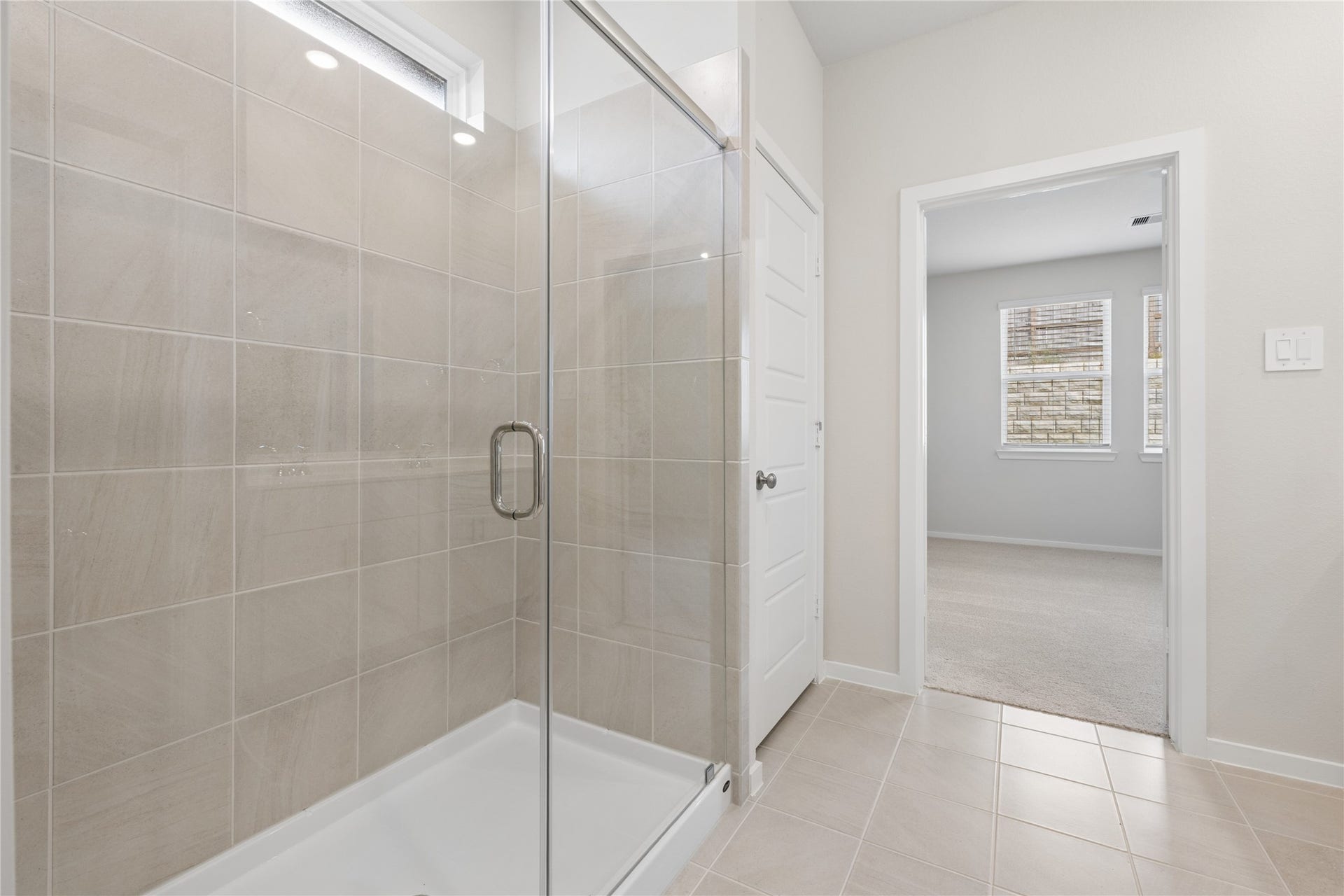 384 Sunrise Ranch Dr, Montgomery, TX 77316 Spacious bathroom features a modern glass-enclosed shower with elegant tile work.