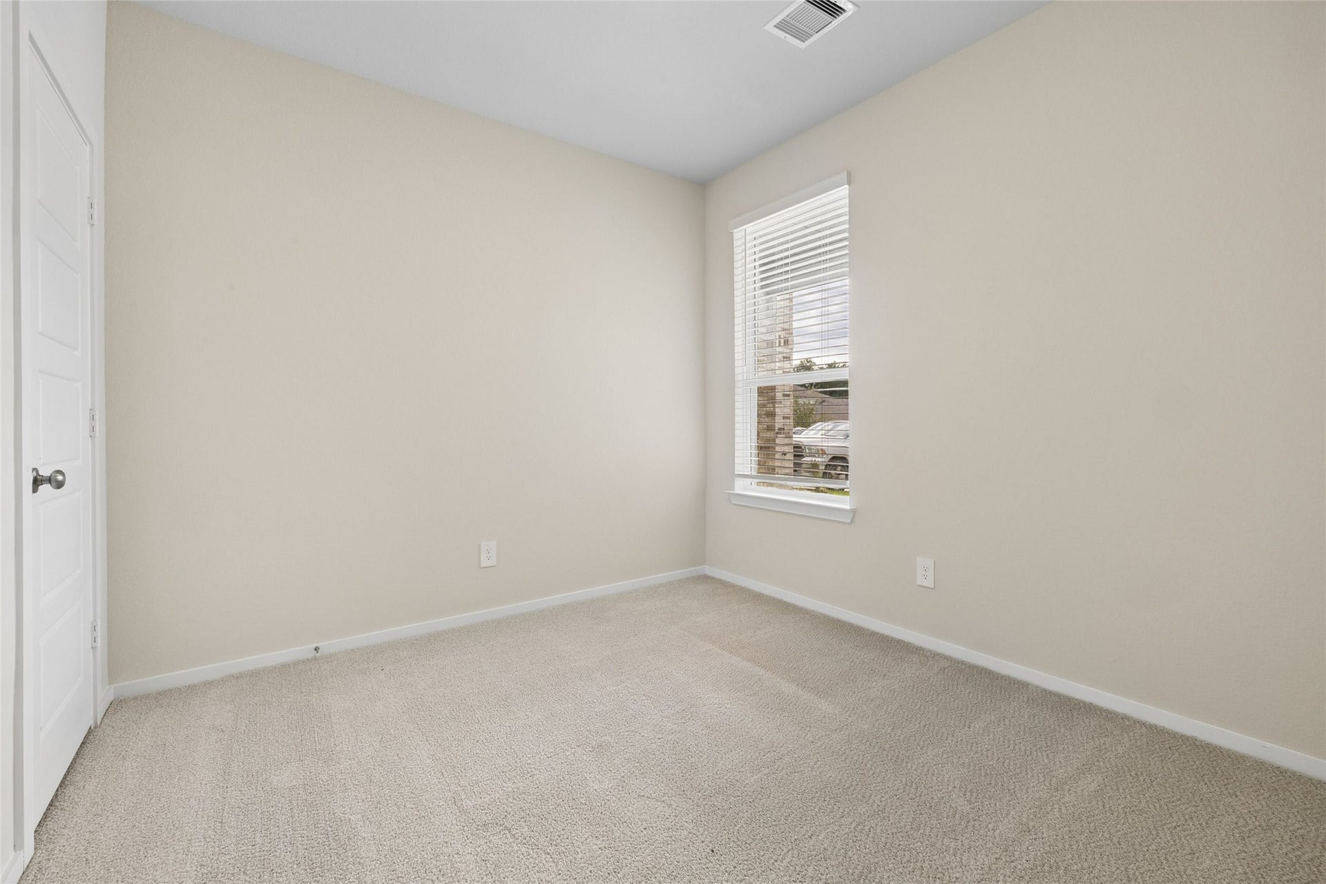 384 Sunrise Ranch Dr, Montgomery, TX 77316 Cozy bedroom with soft carpet flooring, neutral walls, and a bright window allowing natural light to fill the space.